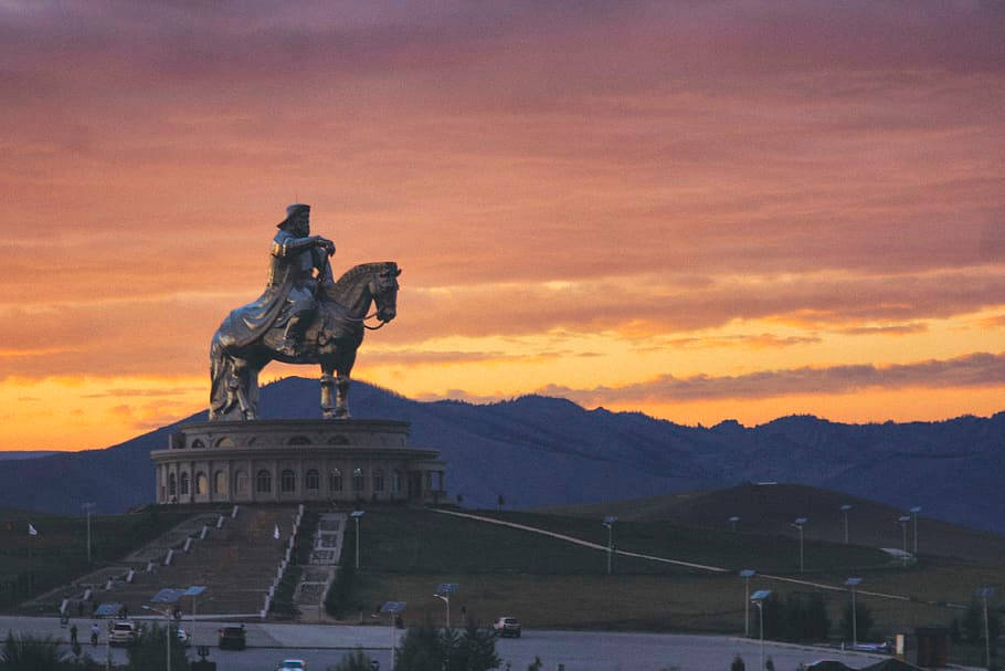 Mongolias Statue Facing The Sunset Background