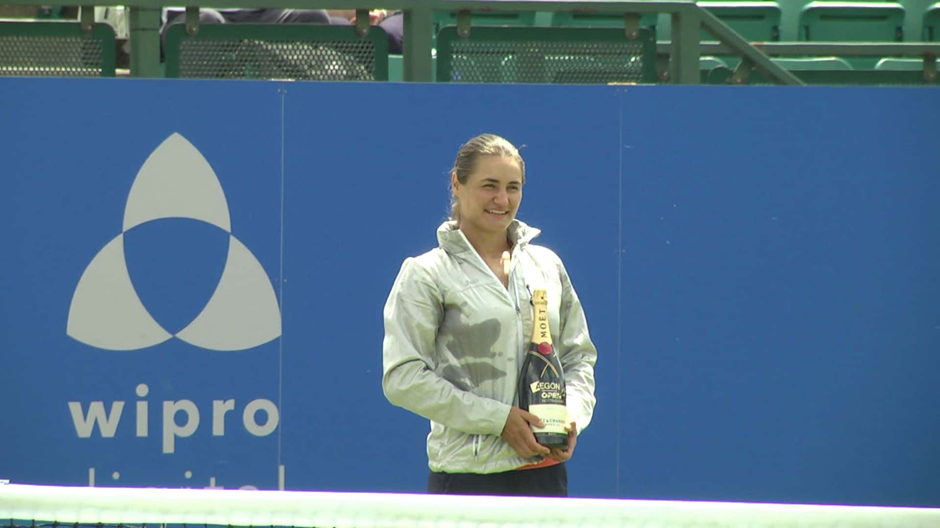 Monica Niculescu Holding Champagne Bottle Background