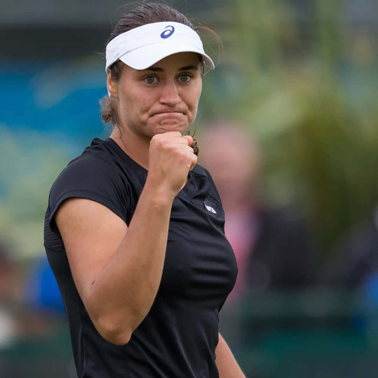 Monica Niculescu Triumphantly Clenches Her Fist On The Tennis Court. Background