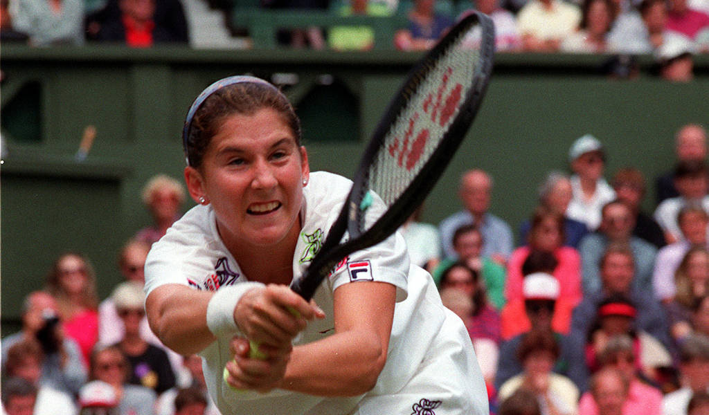 Monica Seles Holding Racket Both Hands Background