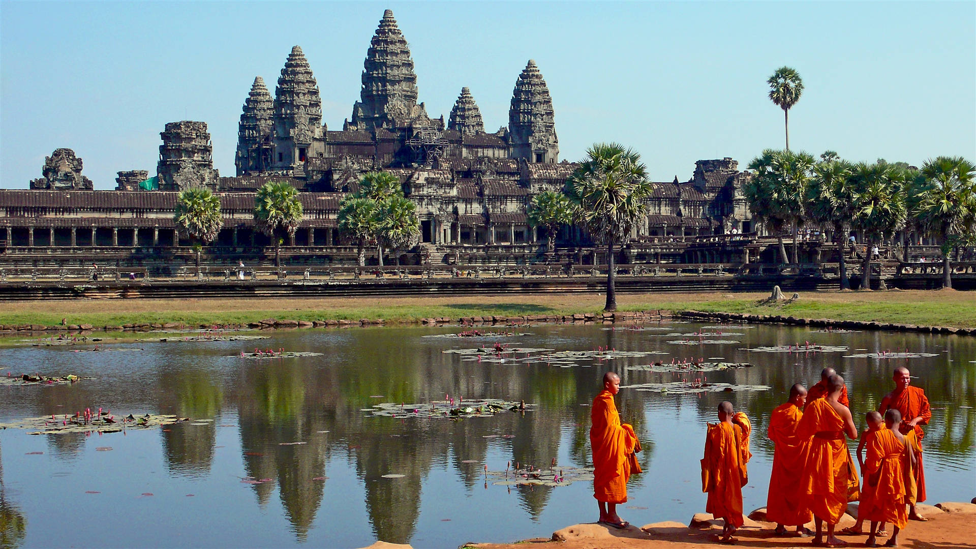 Monks Outside Angkor Wat In Cambodia Background