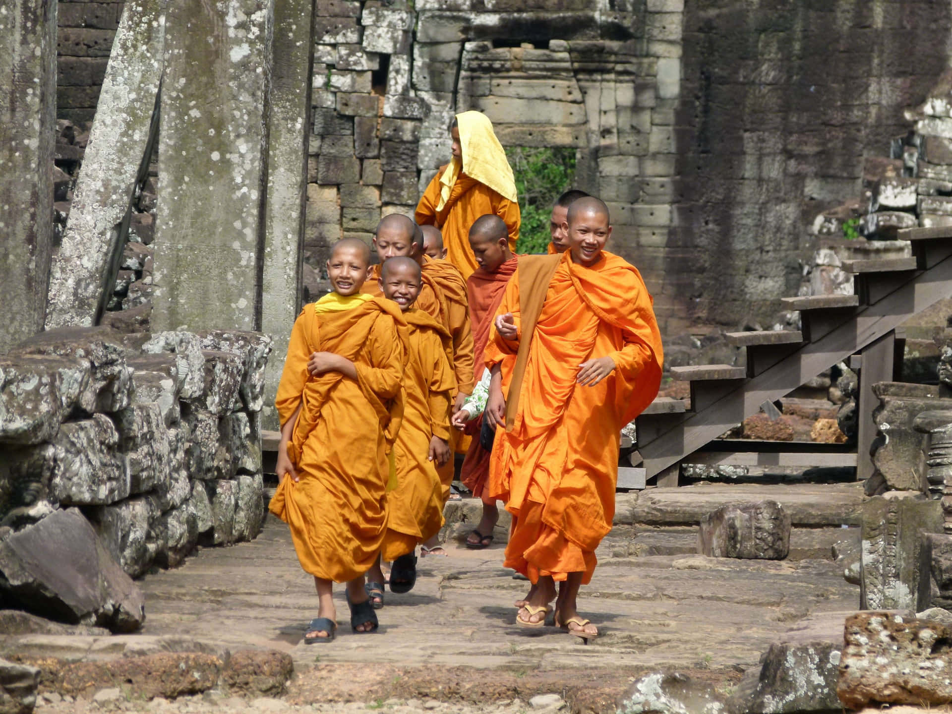 Monks Strolling In The Historical Site Of Angkor Thom Background