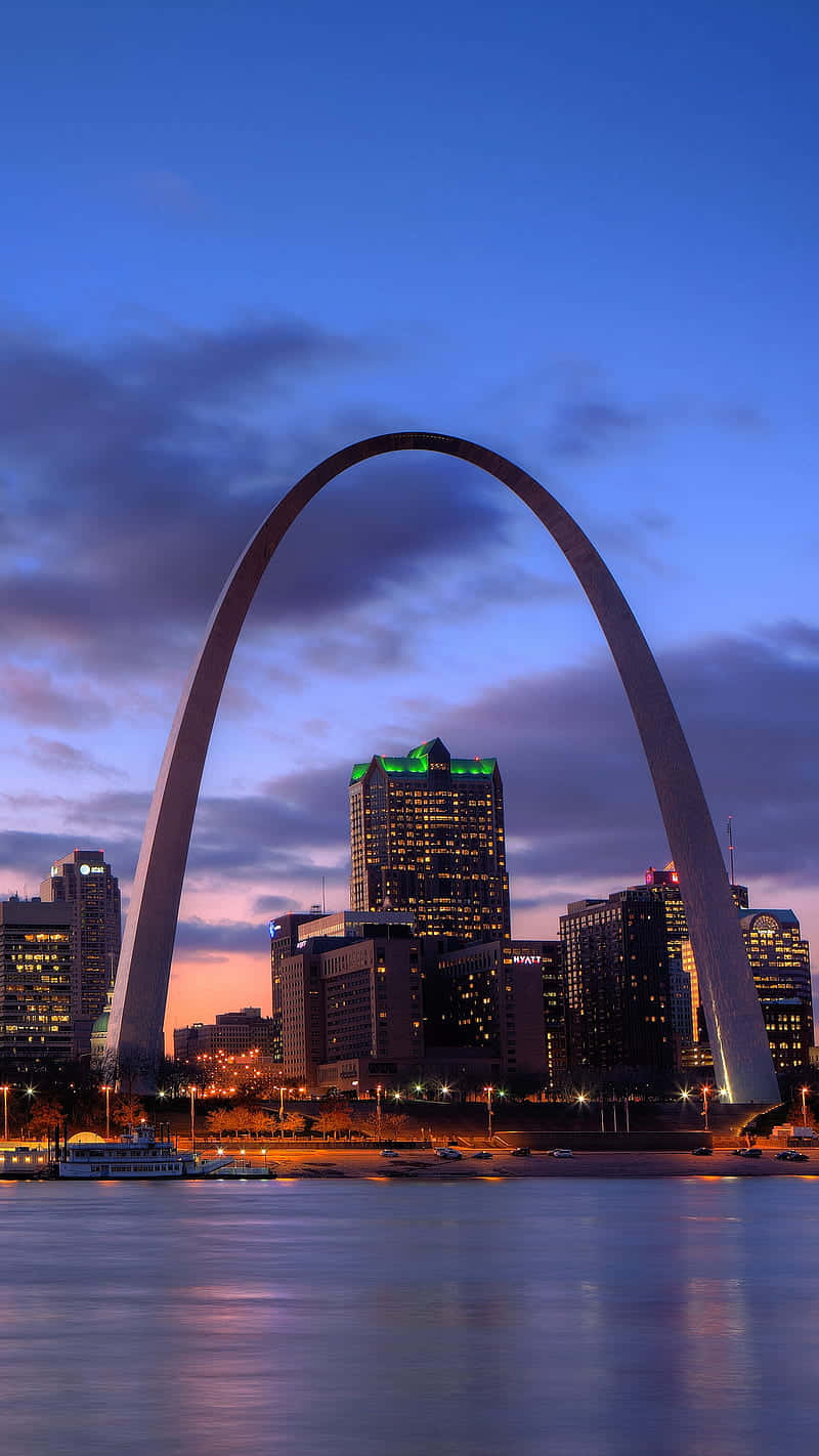 Monochromatic Brilliance - The Gateway Arch Under Menacing Clouds Background