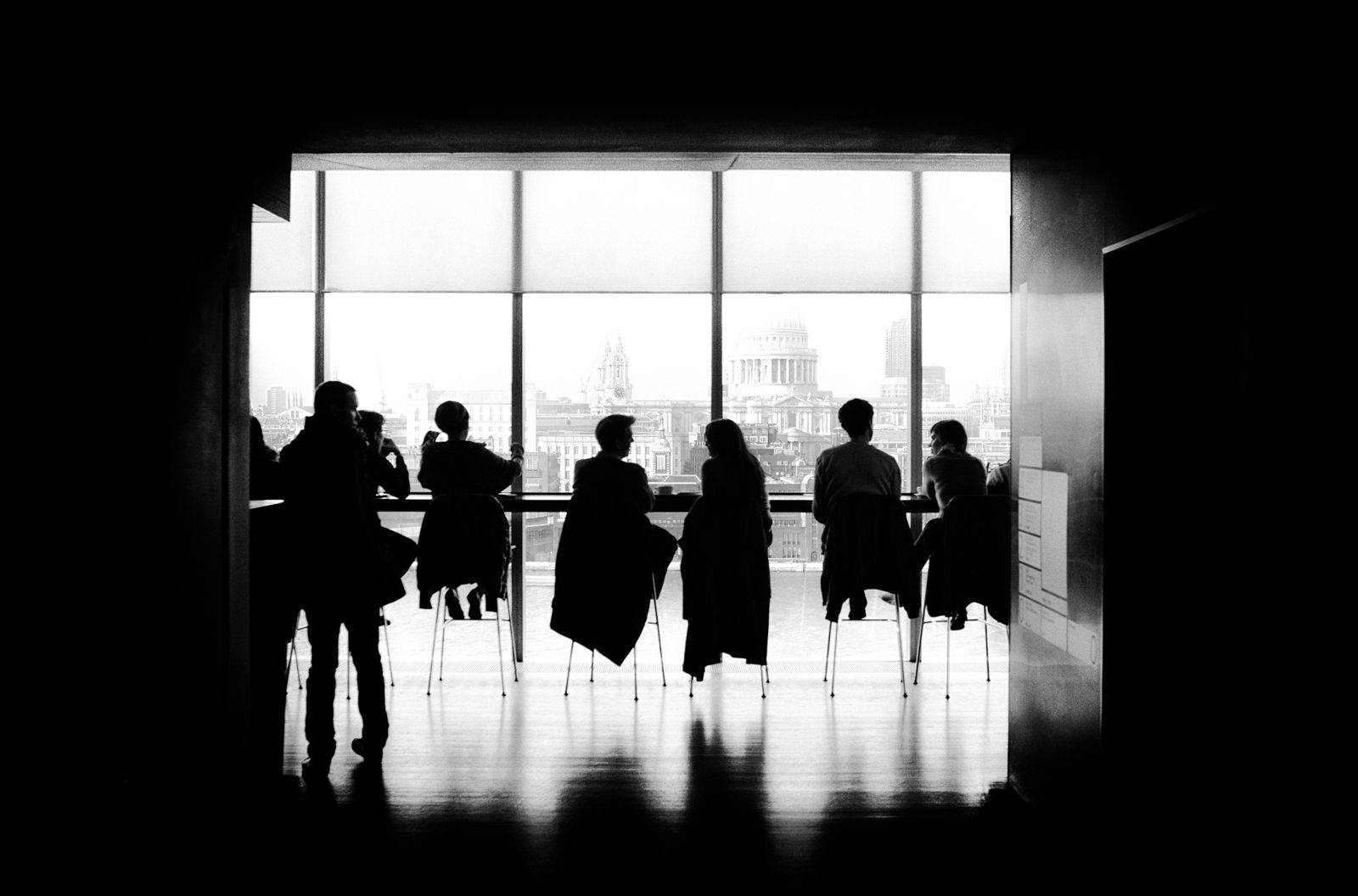 Monochrome Team Photo At Table Background