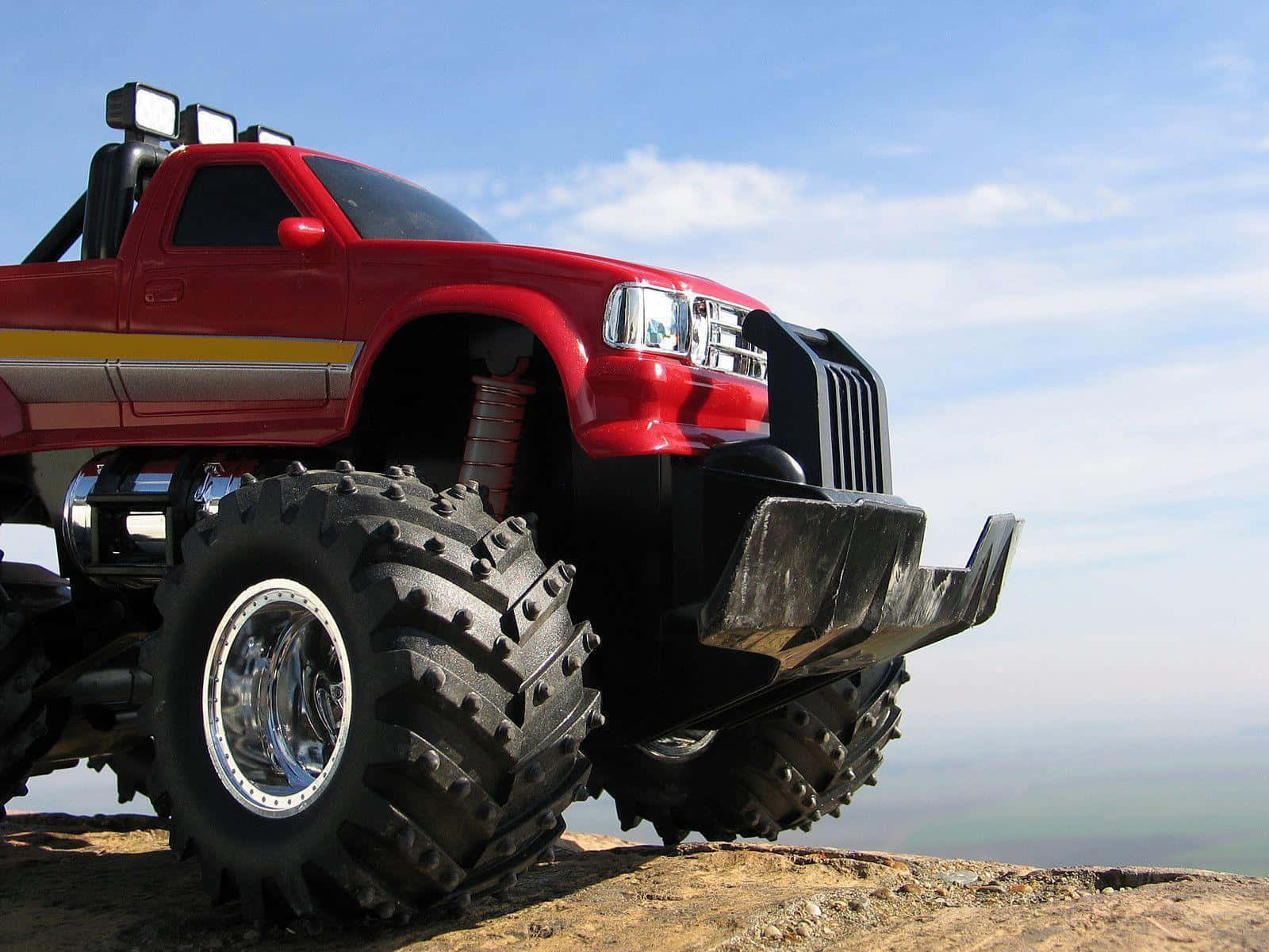 Monster Truck On Edge Of Cliff Background