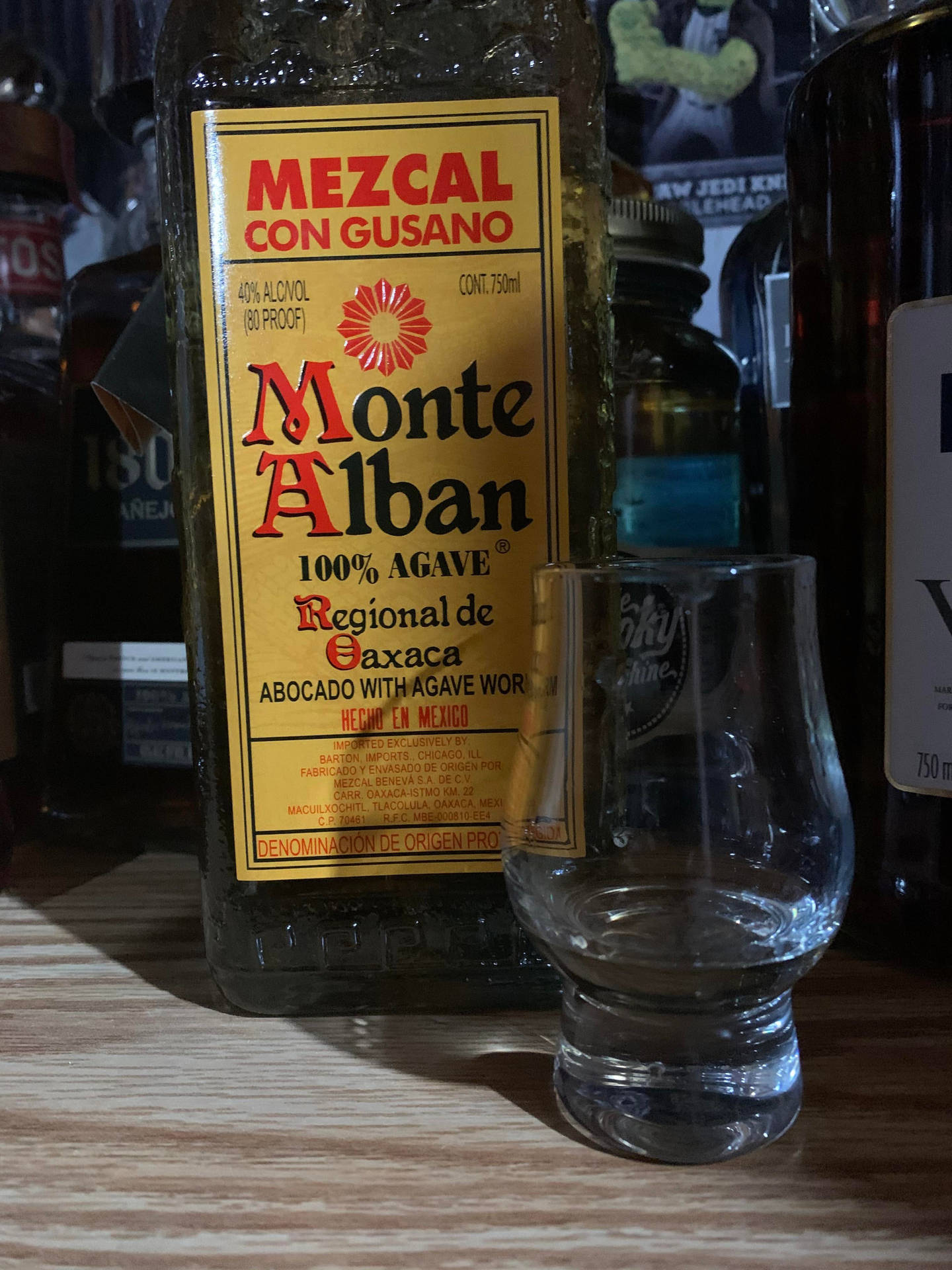 Monte Alban Mezcal Tequila With Shot Glass Background