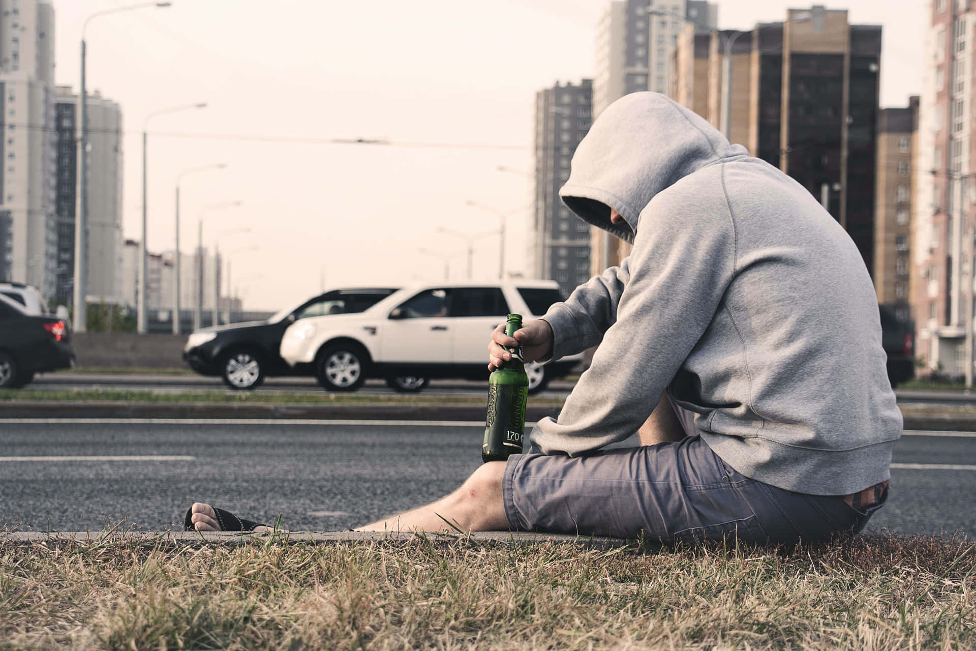 Moody Teen Boy In Grey Hoodie Background