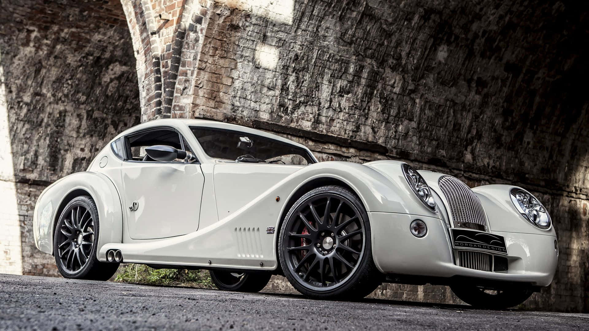 Morgan Sports Car On A Road Background