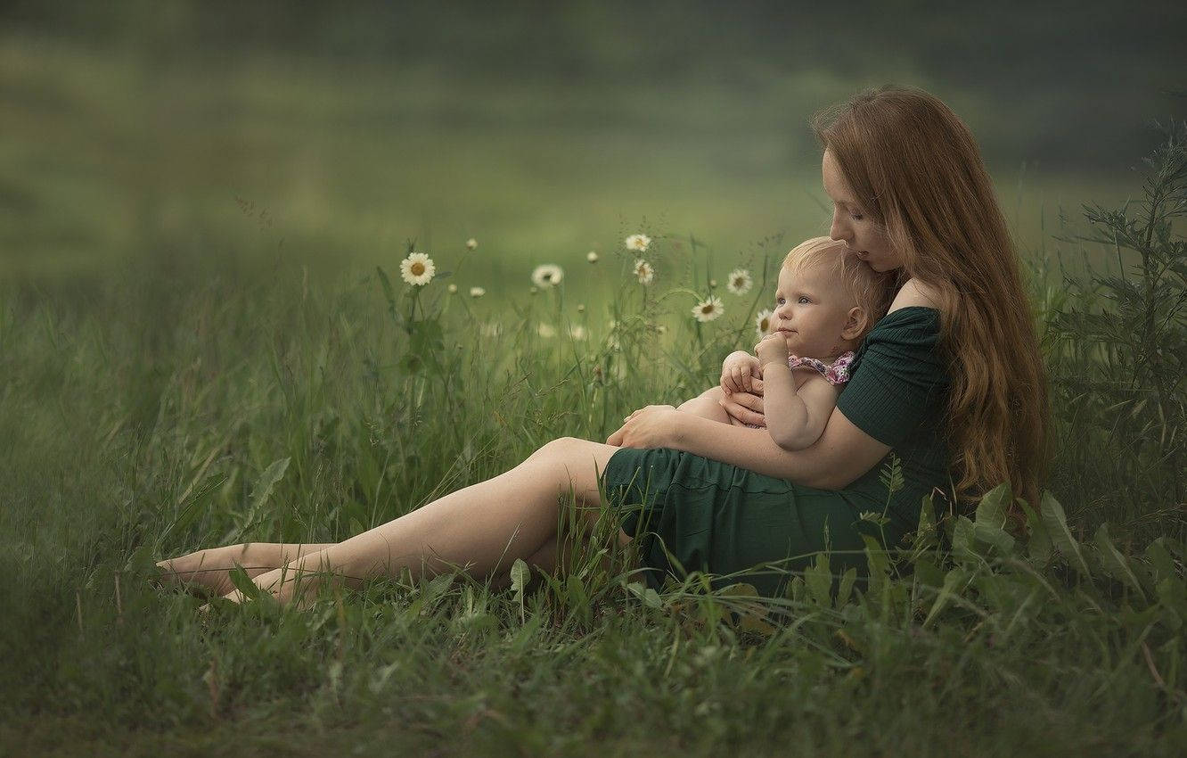 Mother And Baby On Lush Green Field