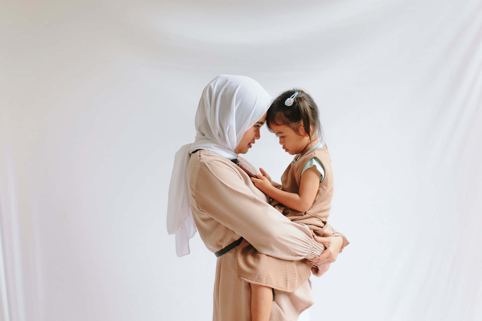 Mother And Daughter Facing Each Other Representing Tangible Love Of A Mother Background