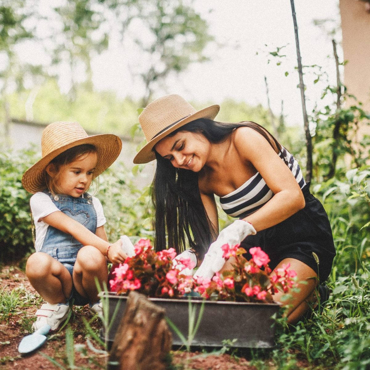 Mother And Daughter In Gardening Hat