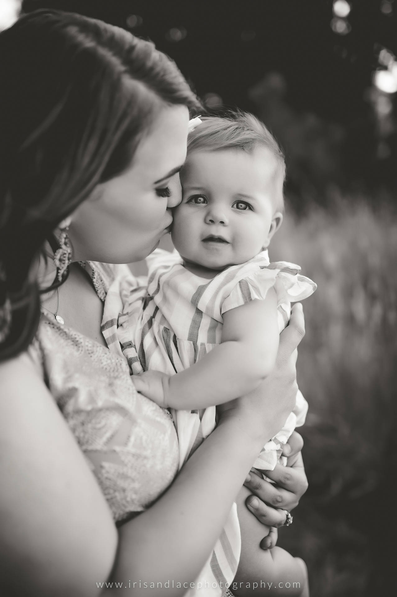 Mother Carrying And Kissing Beautiful Baby Background