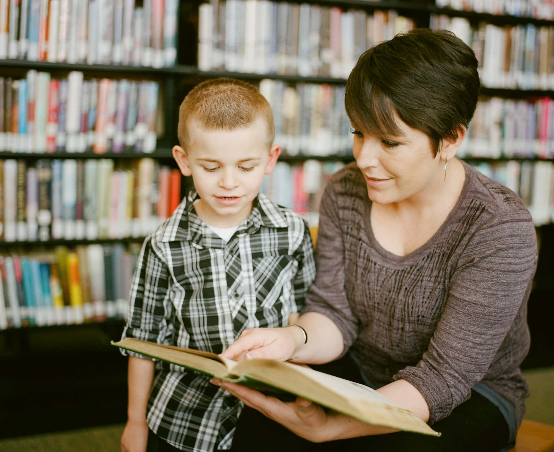 Motherand Son Reading Together Library Background