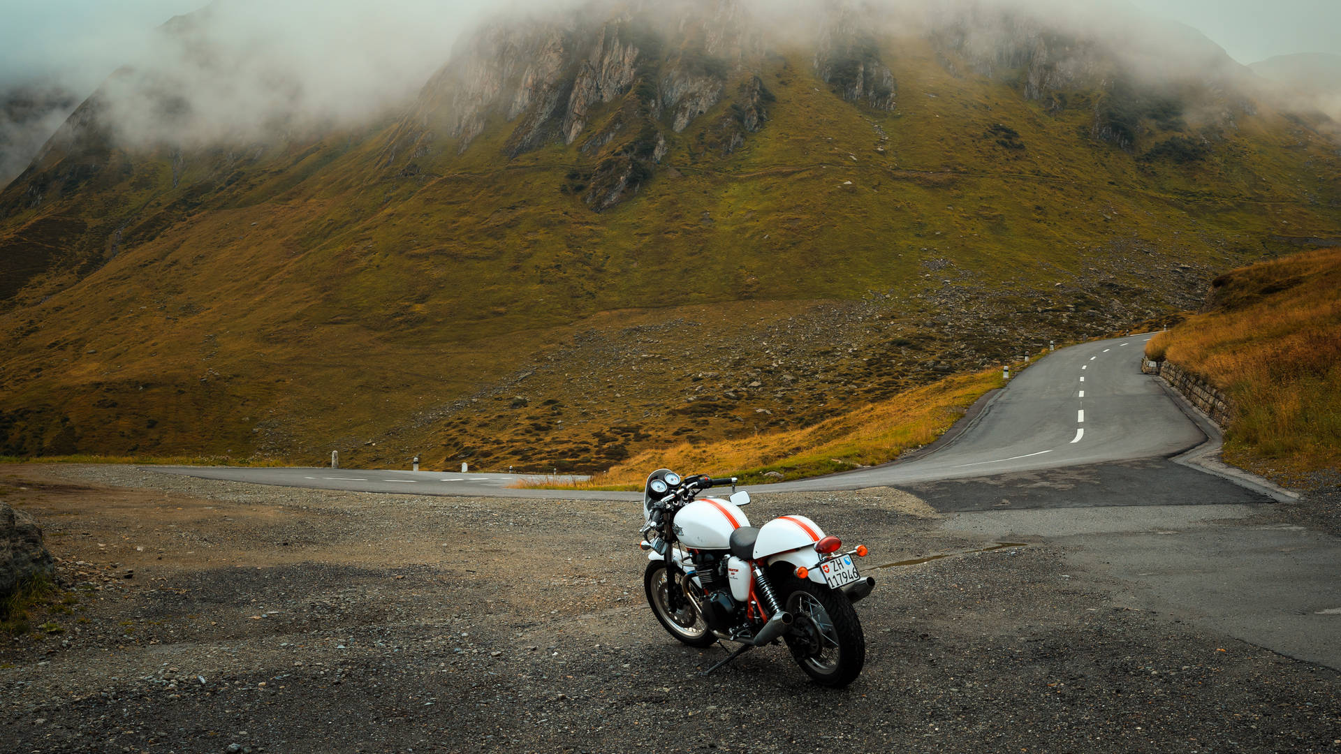 Motorcycle Parked Near Mountains Background