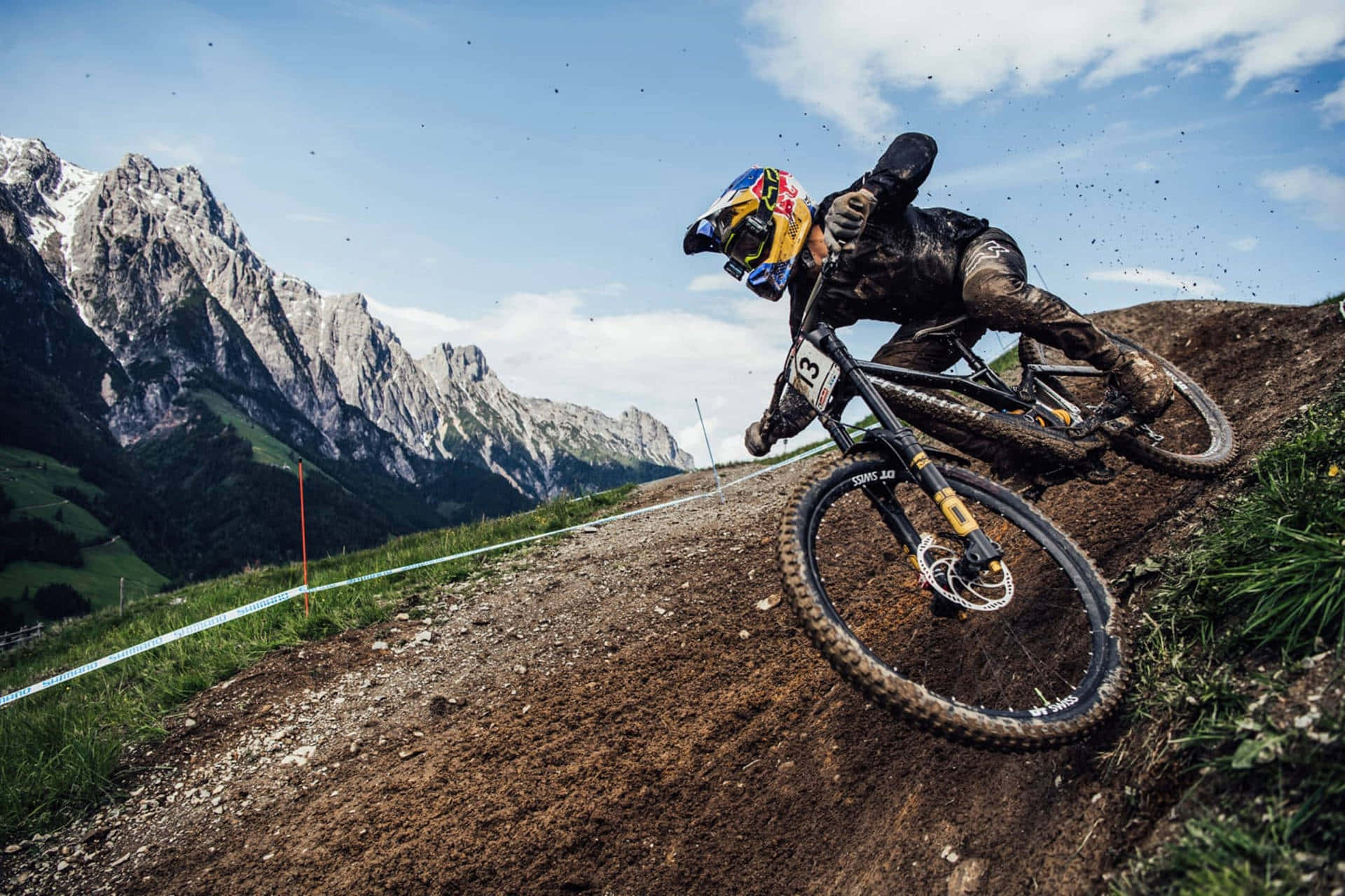 Mountain Biker Speeding Downhill Alpine Background Background