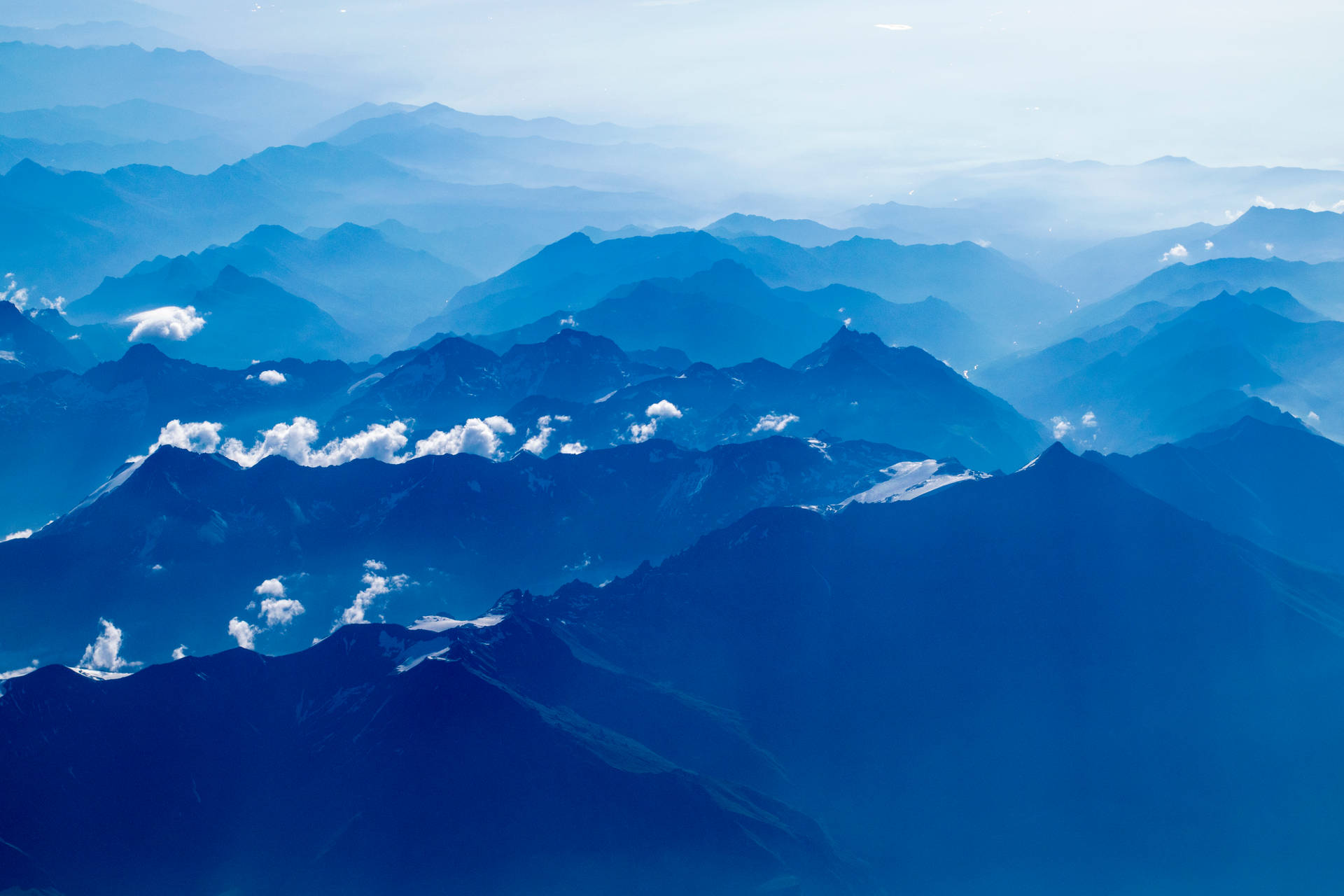 Mountain Ranges Under Blue Sky Background