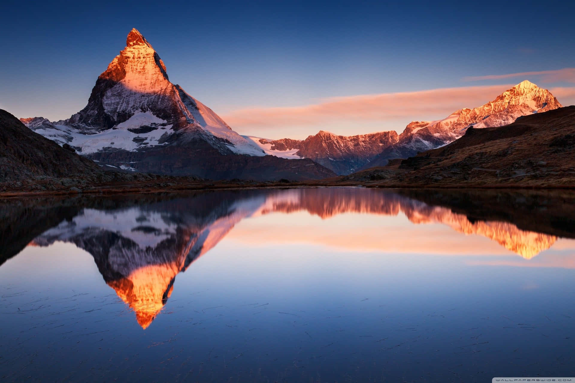Mountain Reflection On Superficial Lake Water
