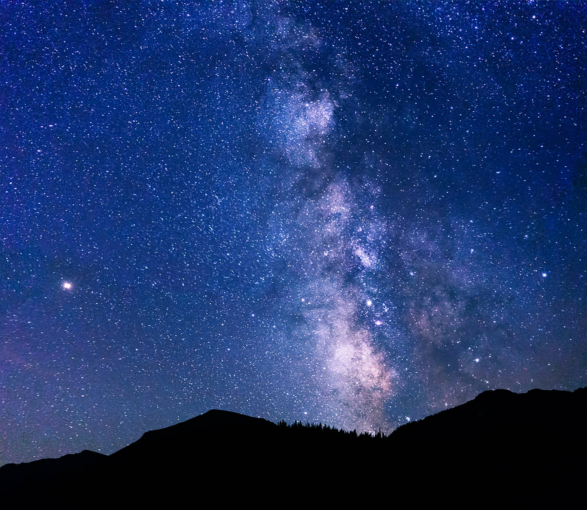 Mountain Silhouette With Andromeda Galaxy Background