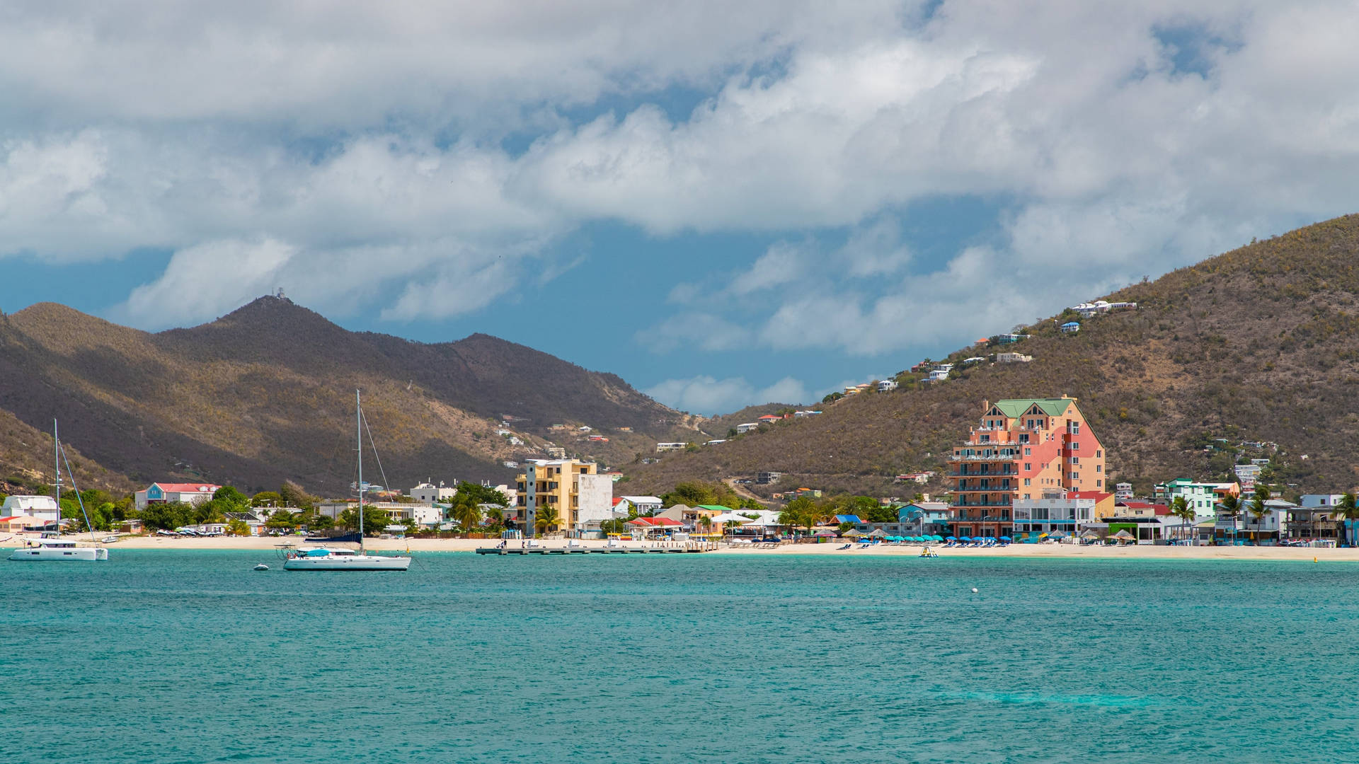 Mountains Fronting The Beach In Sint Maarten Background