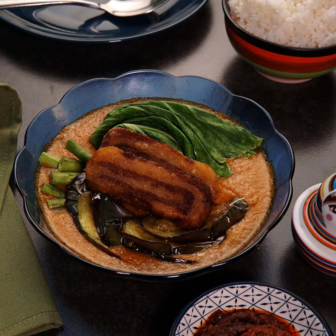 Mouth-watering Kare-kare Topped With Deep-fried Pork Background