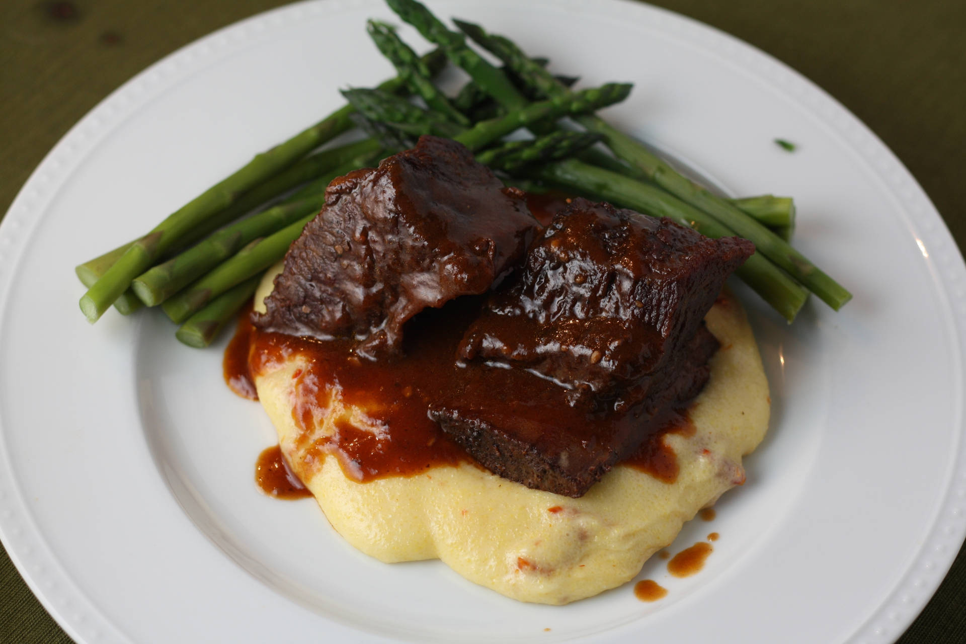 Mouth Watering Short Ribs Served Over Creamy Polenta