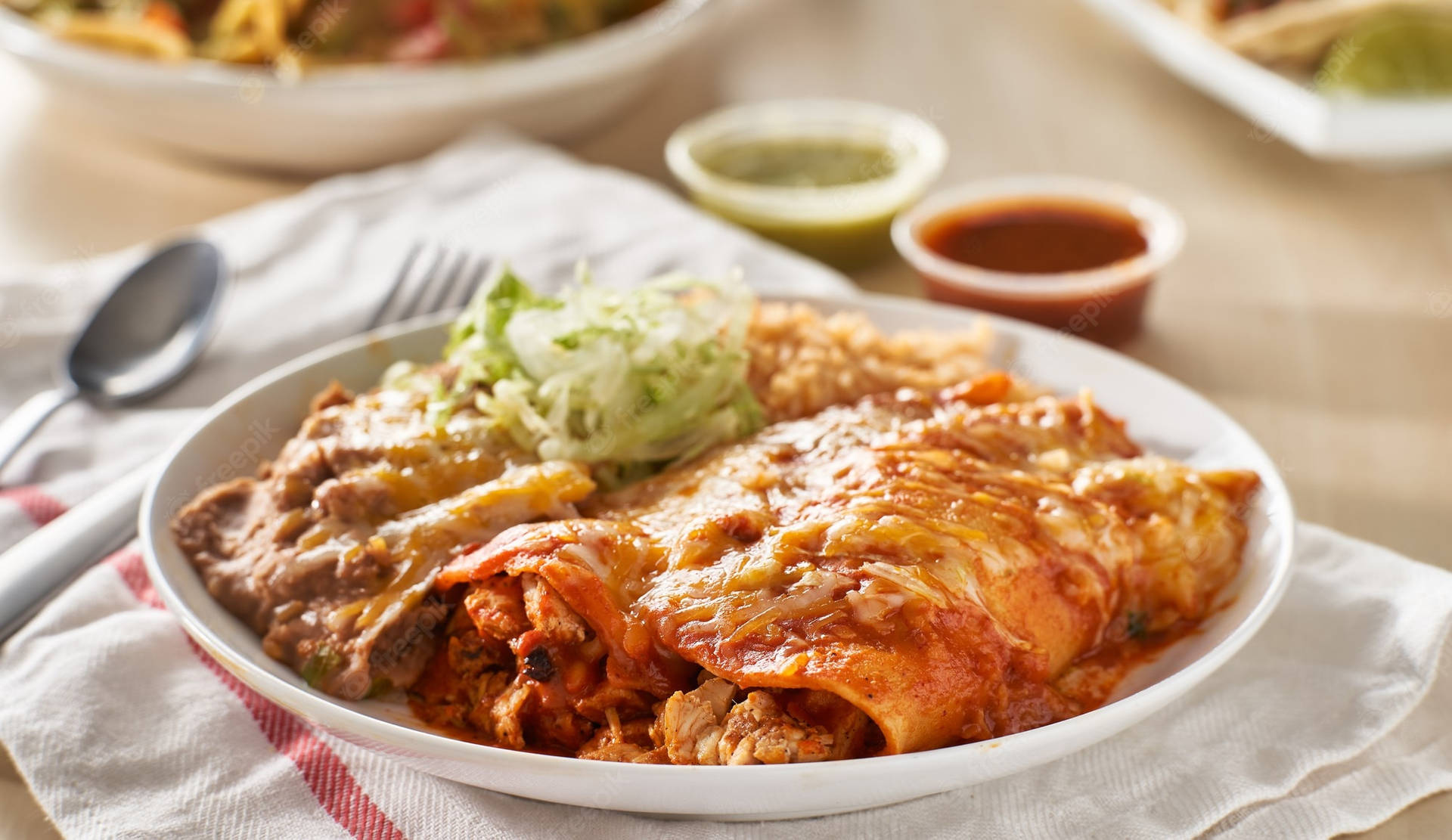 Mouthwatering Creamy Enchiladas Plated To Perfection Background