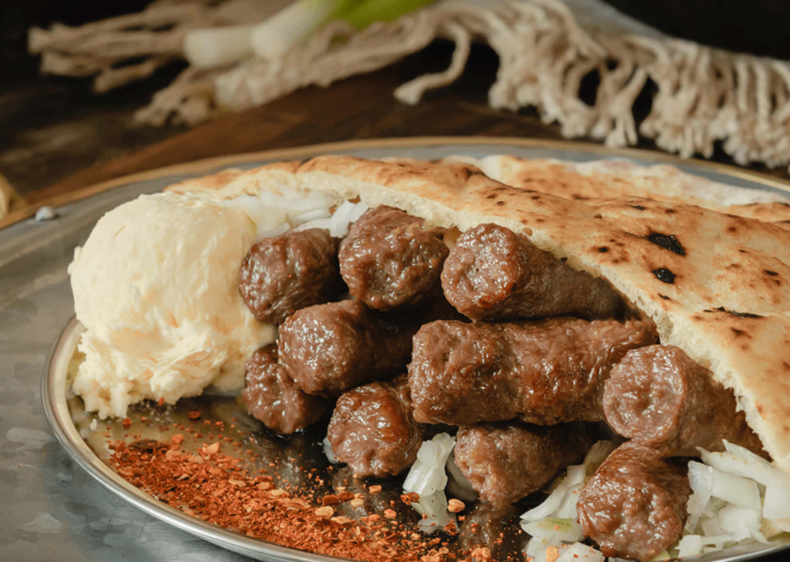 Mouthwatering Grilled Ćevapi Served With Chili Flakes Background