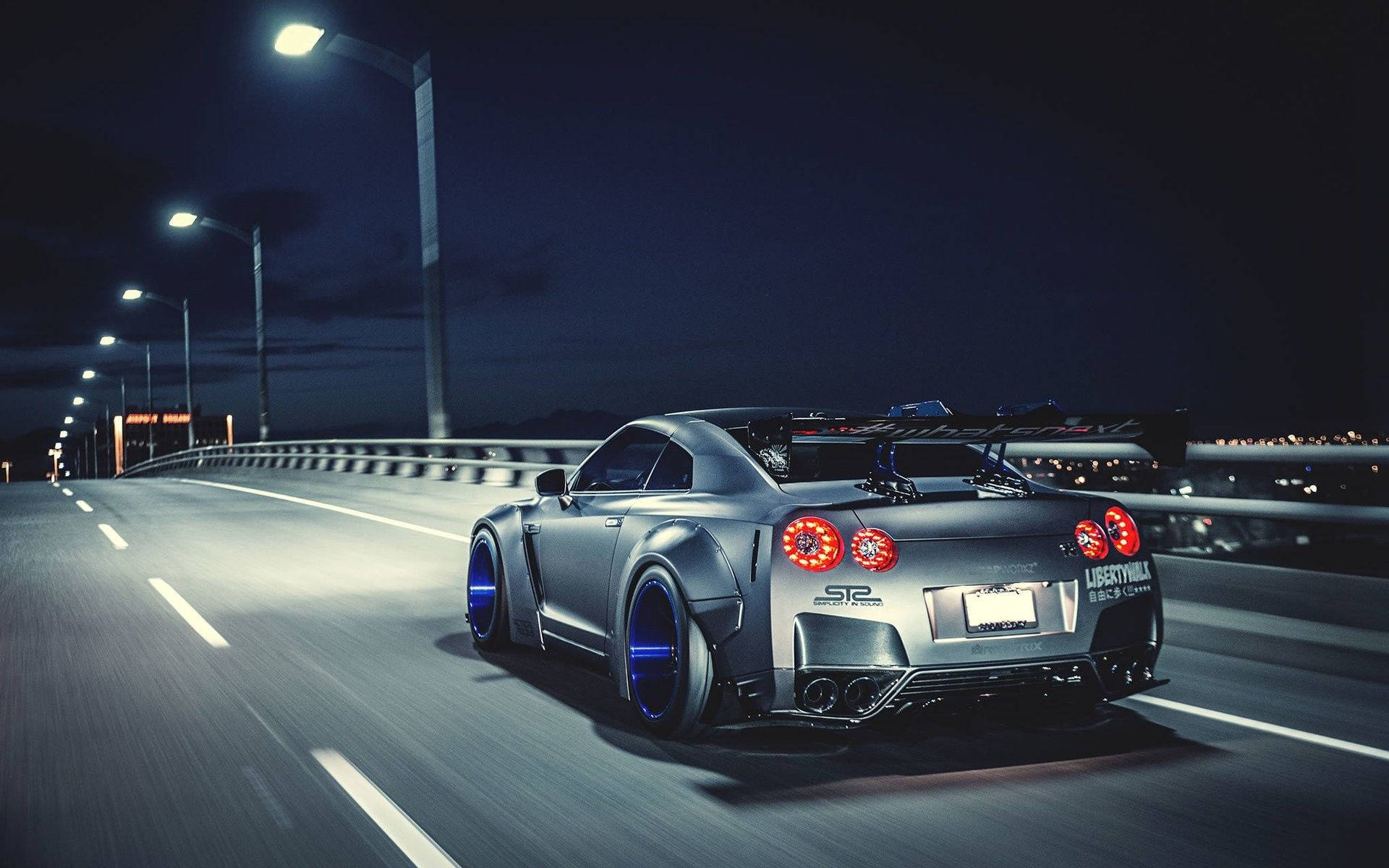 Moving Silver Nissan Gtr Along The Road Background