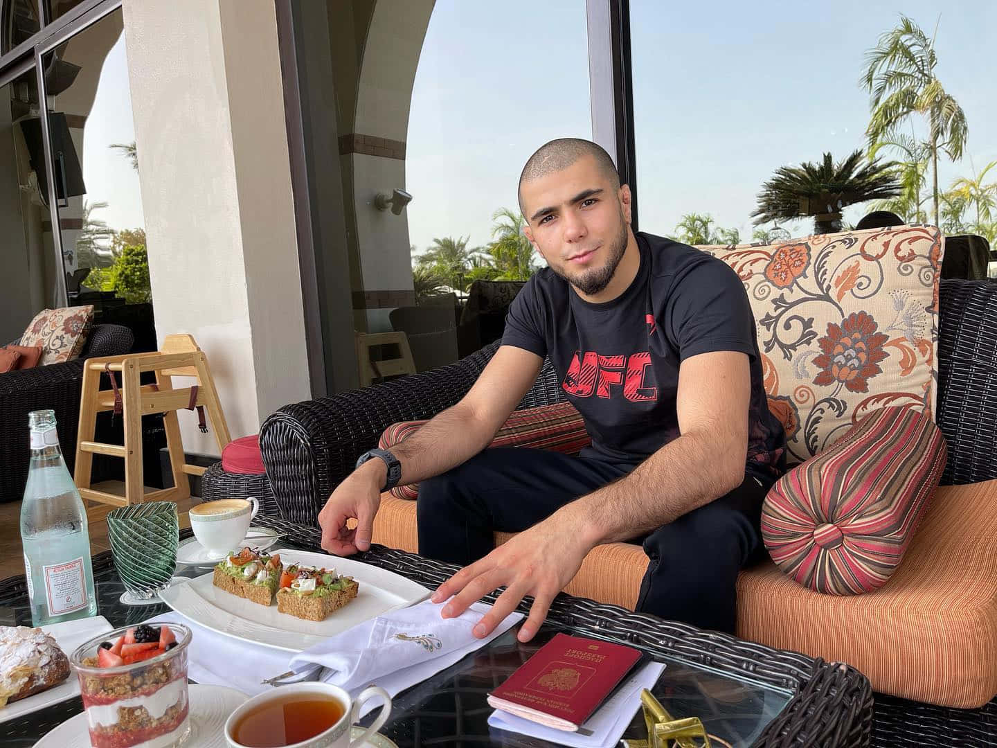 Muhammad Mokaev Eating On Couch Background