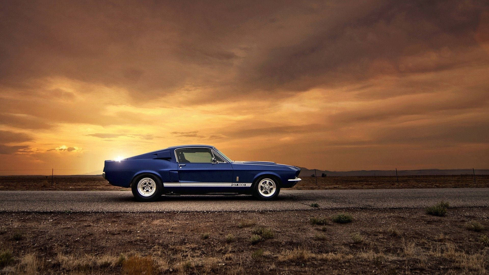 Muscle Car Driving During Sunset Background