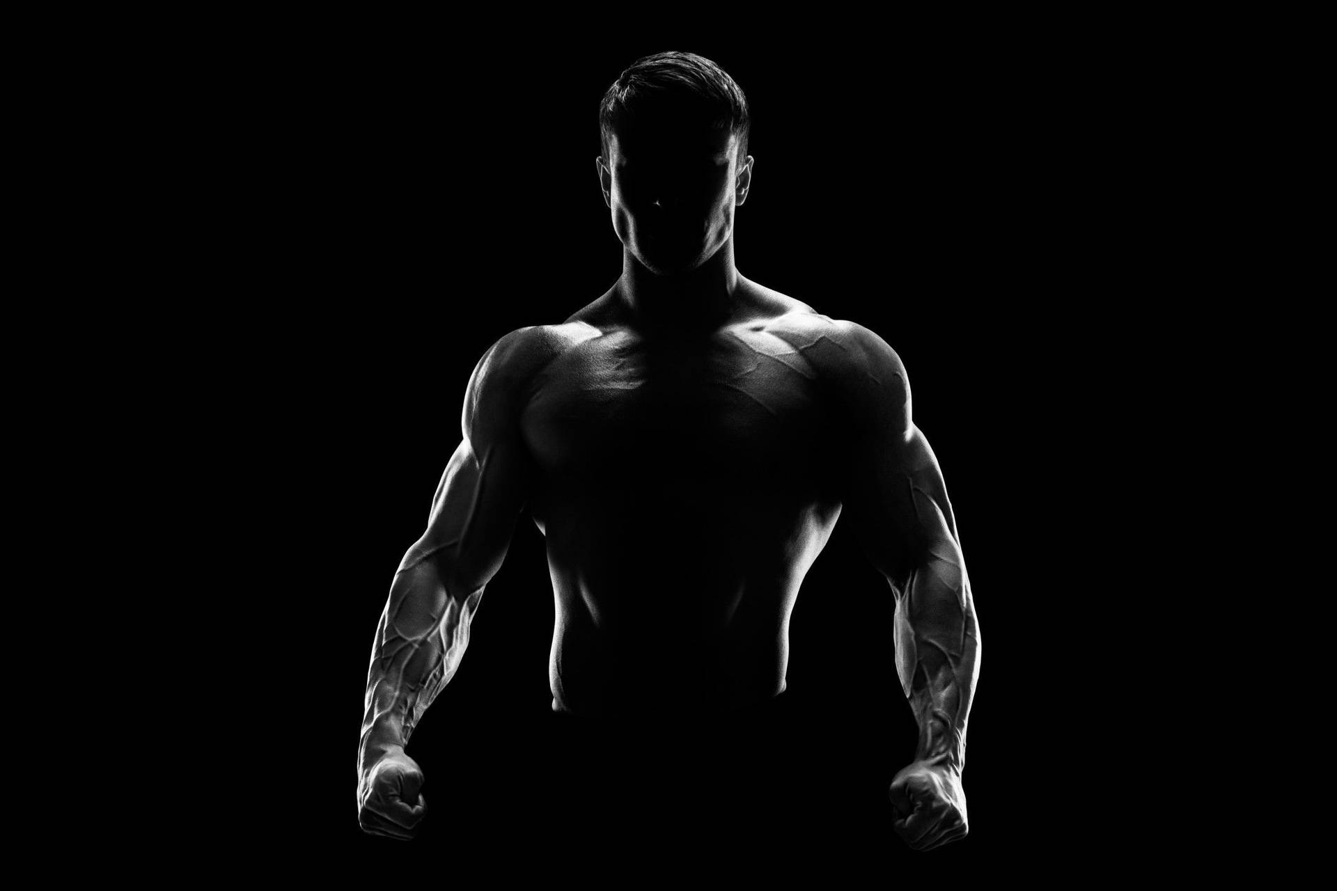 Muscle Man Silhouette In The Dark Background