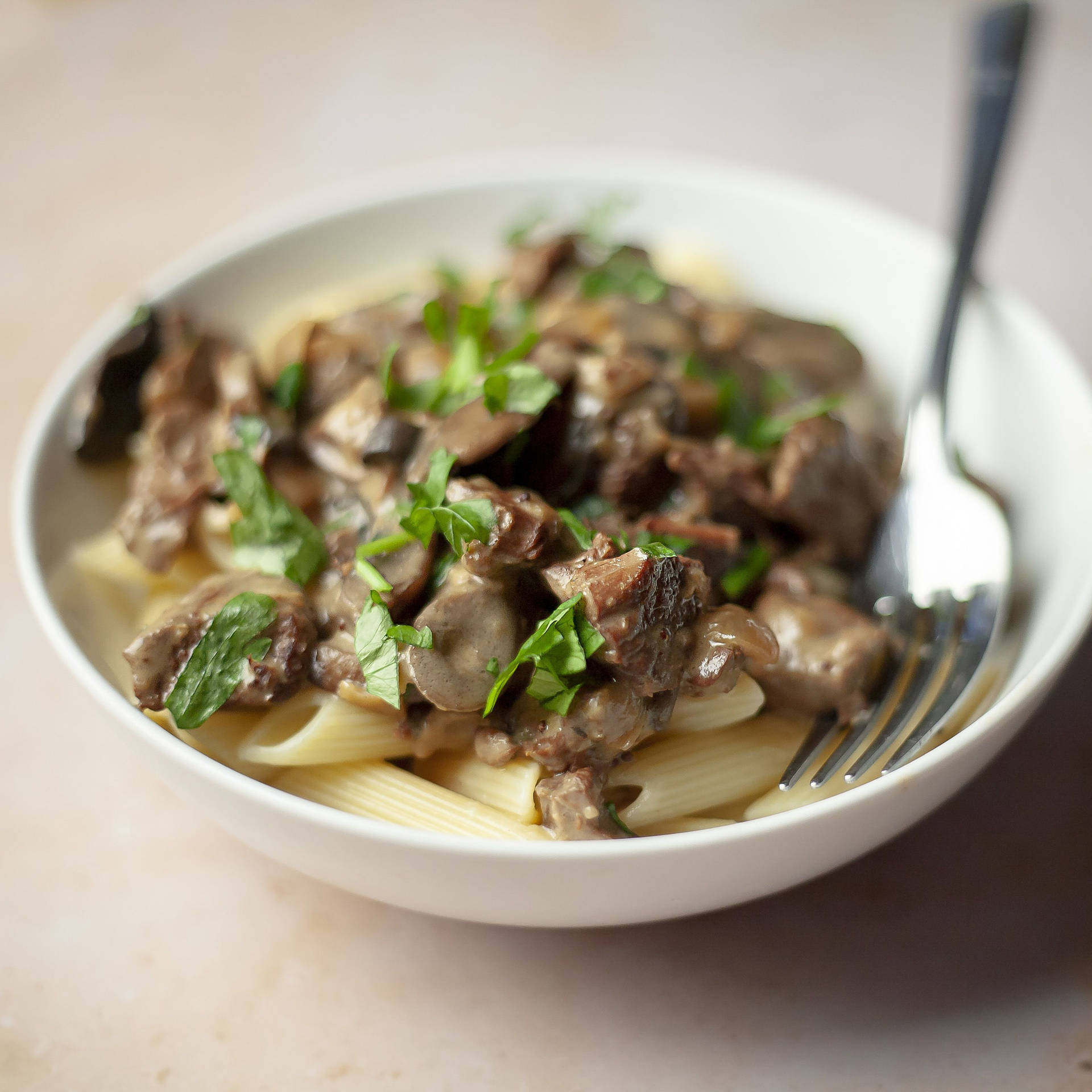 Mushrooms And Beef Stroganoff On Penne Pasta Background