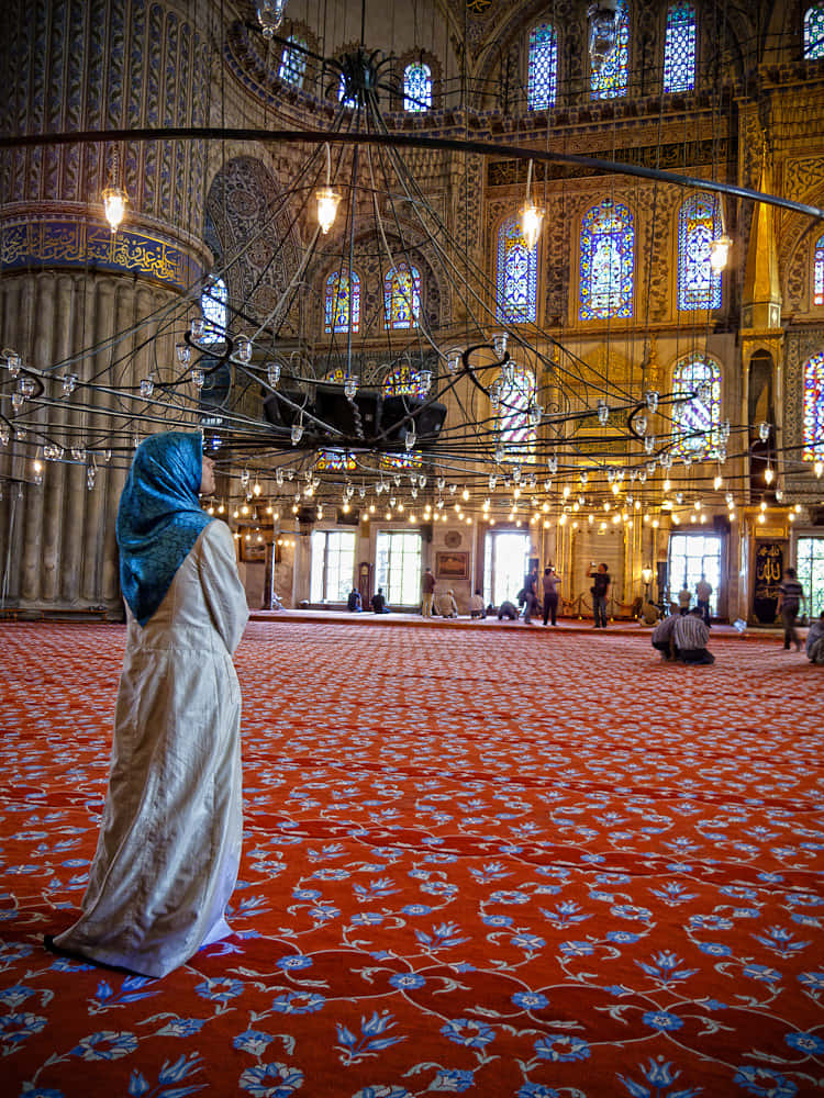 Muslim Woman Inside The Blue Mosque Background