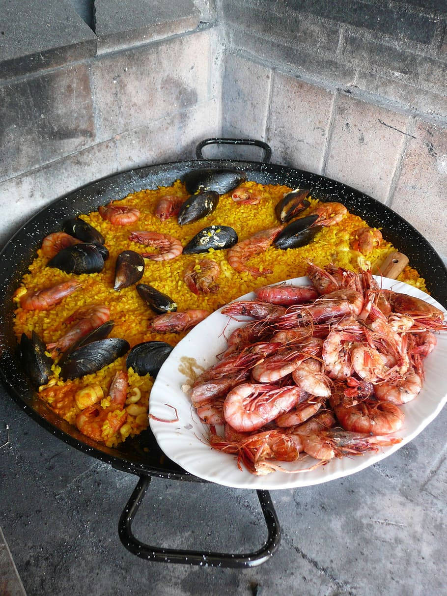 Mussel Paella With A Plate Of Prawns Background