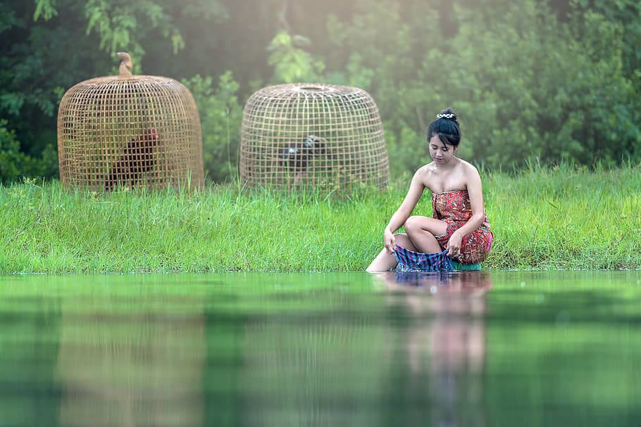 Myanmar Girl Washing Clothes In River Background