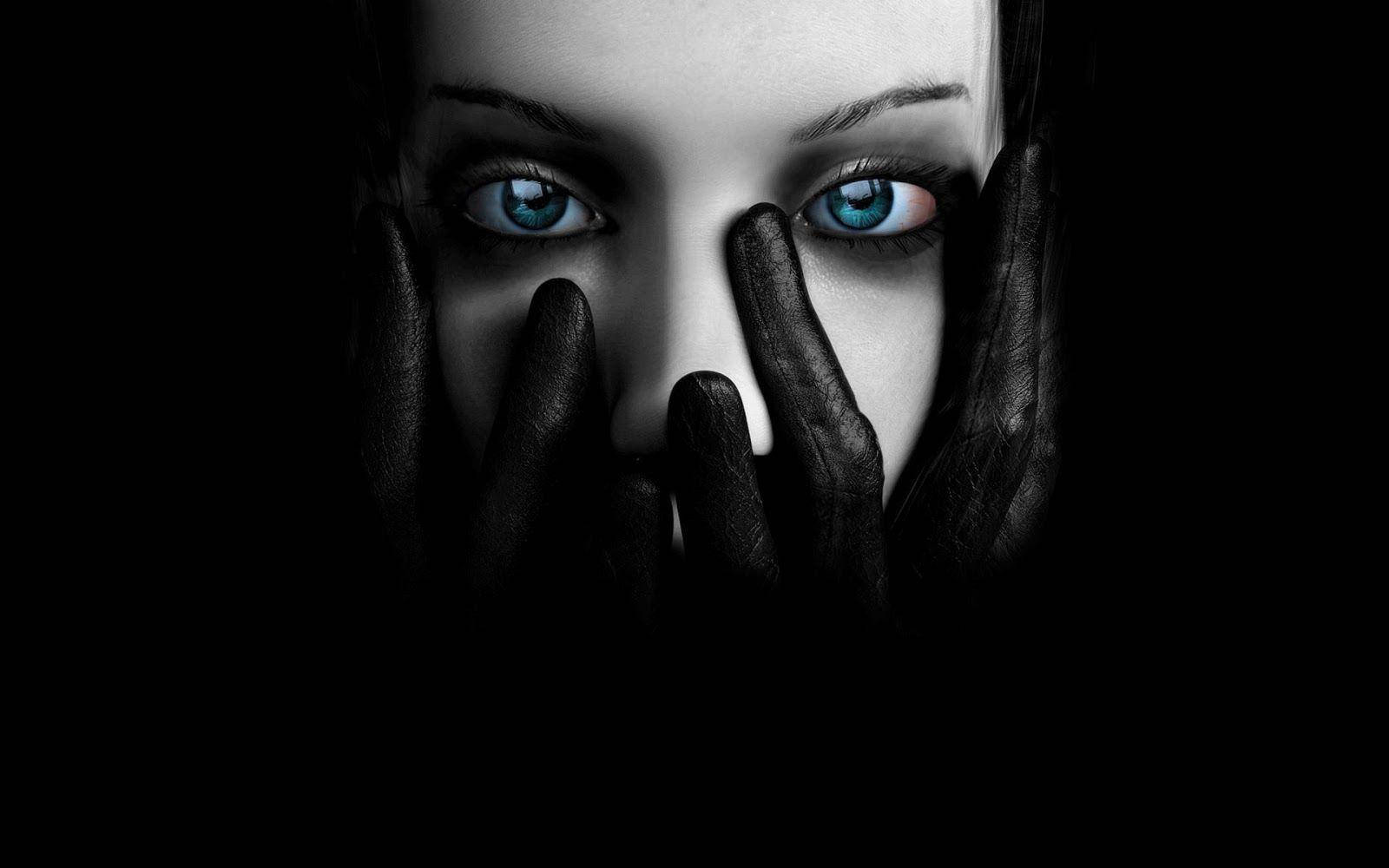 Mysterious Blue-eyed Woman In Dark Background