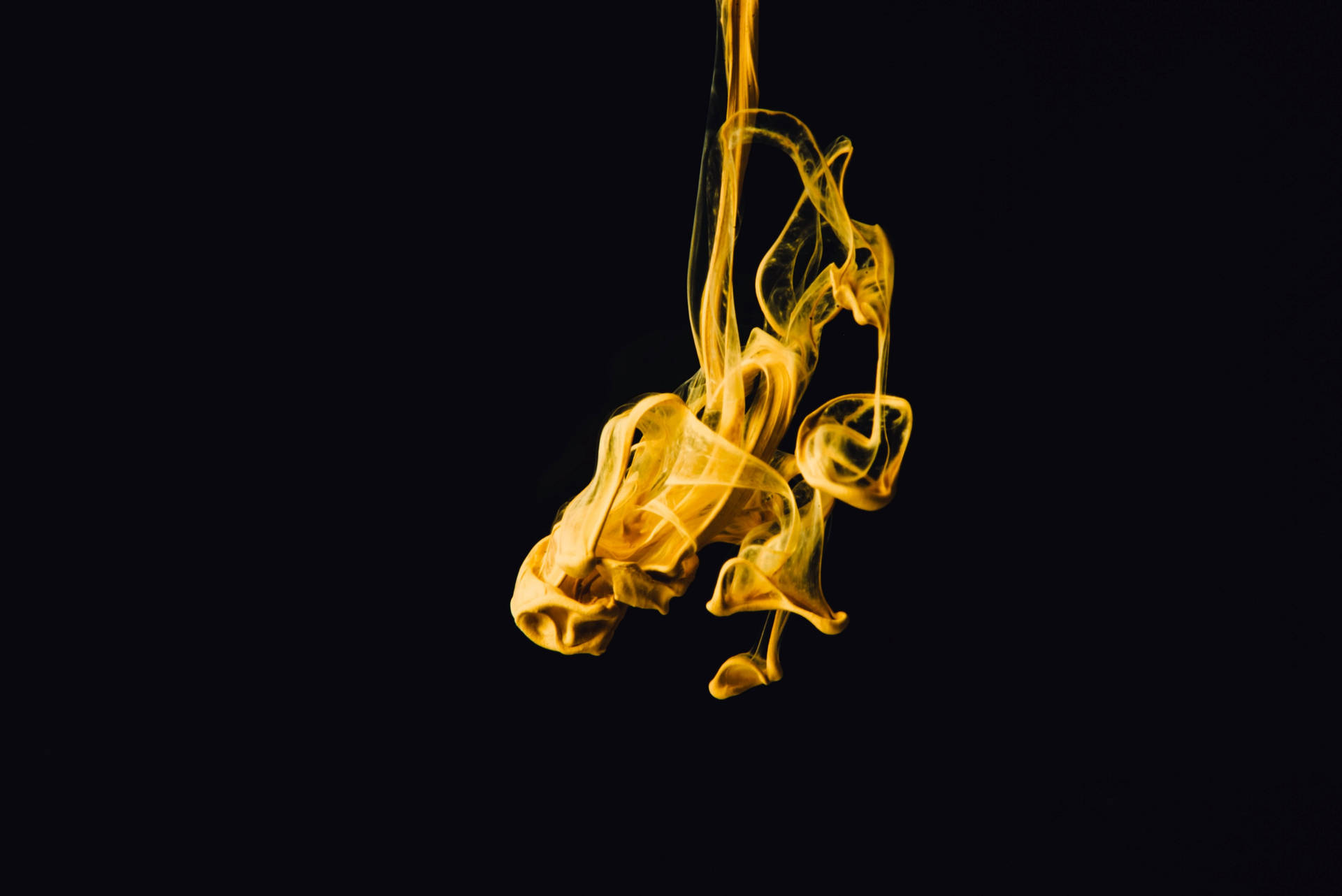 Mysterious Yellow Volatile Substance Against A Dark Background Background