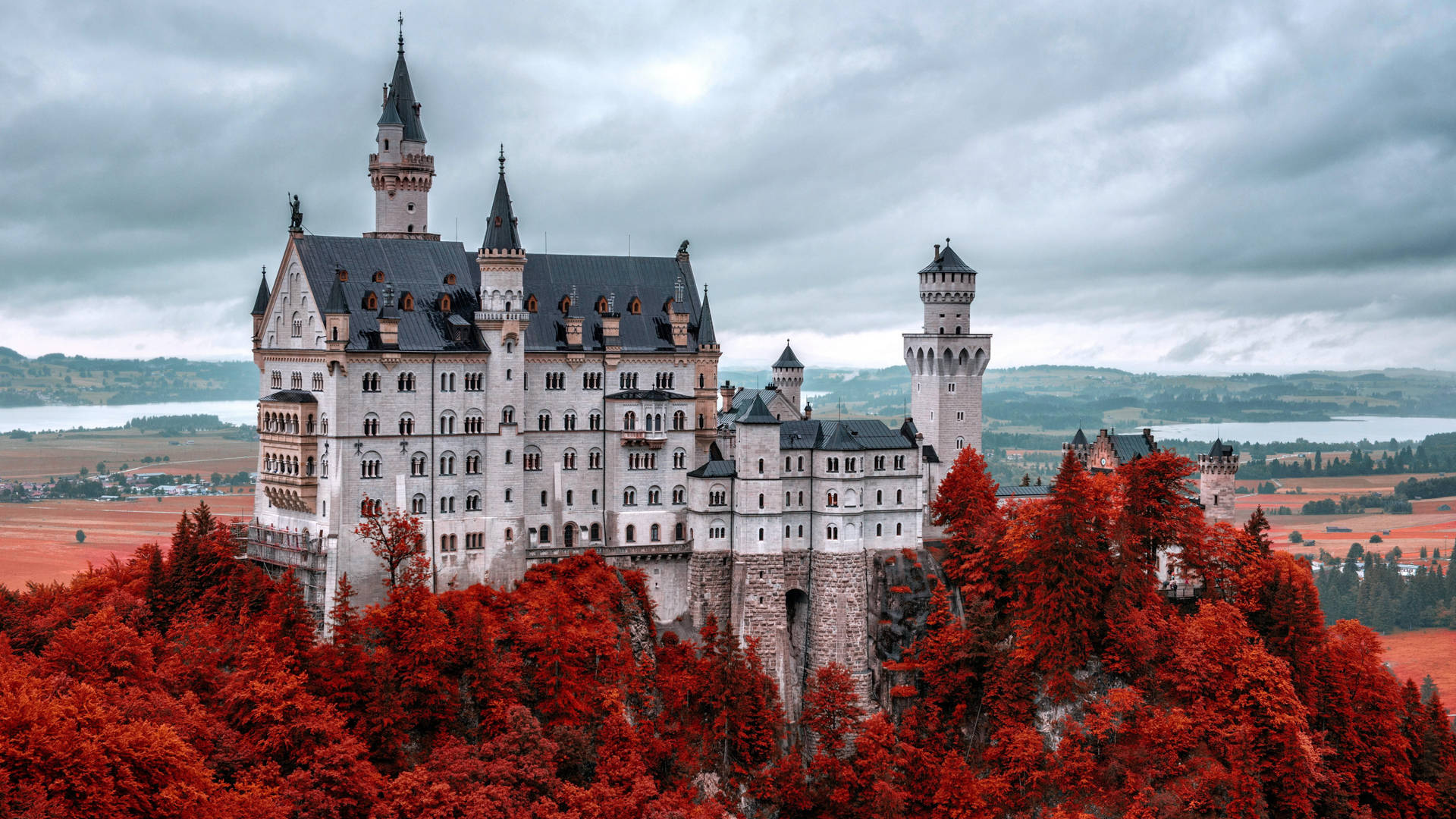 Mystical Neuschwanstein Castle Amidst Autumnal Beauty Background