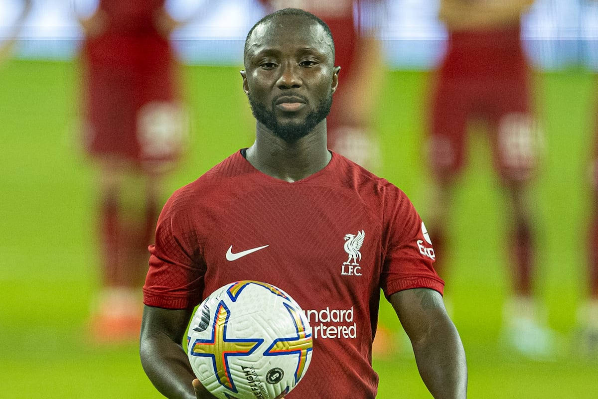 Naby Keita Holding Football Background