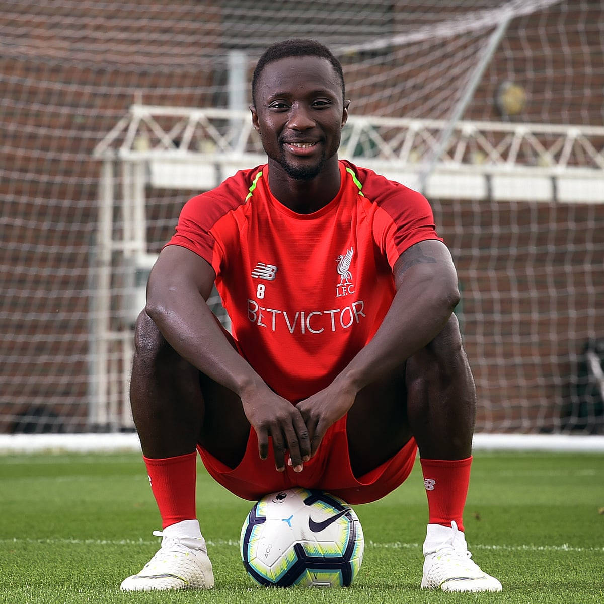 Naby Keita Sitting On Ball Background