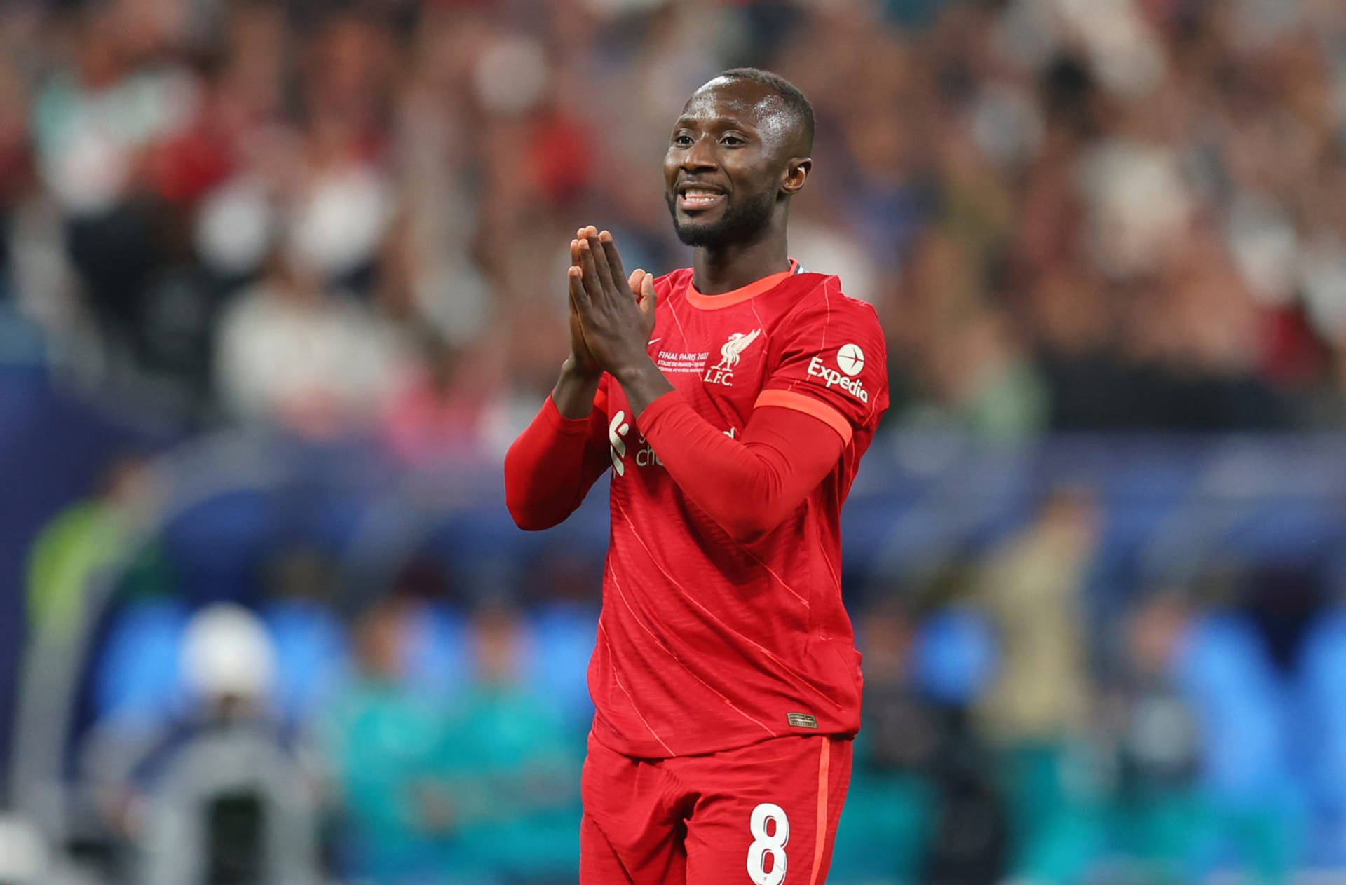 Naby Keita Smiling Brightly Background