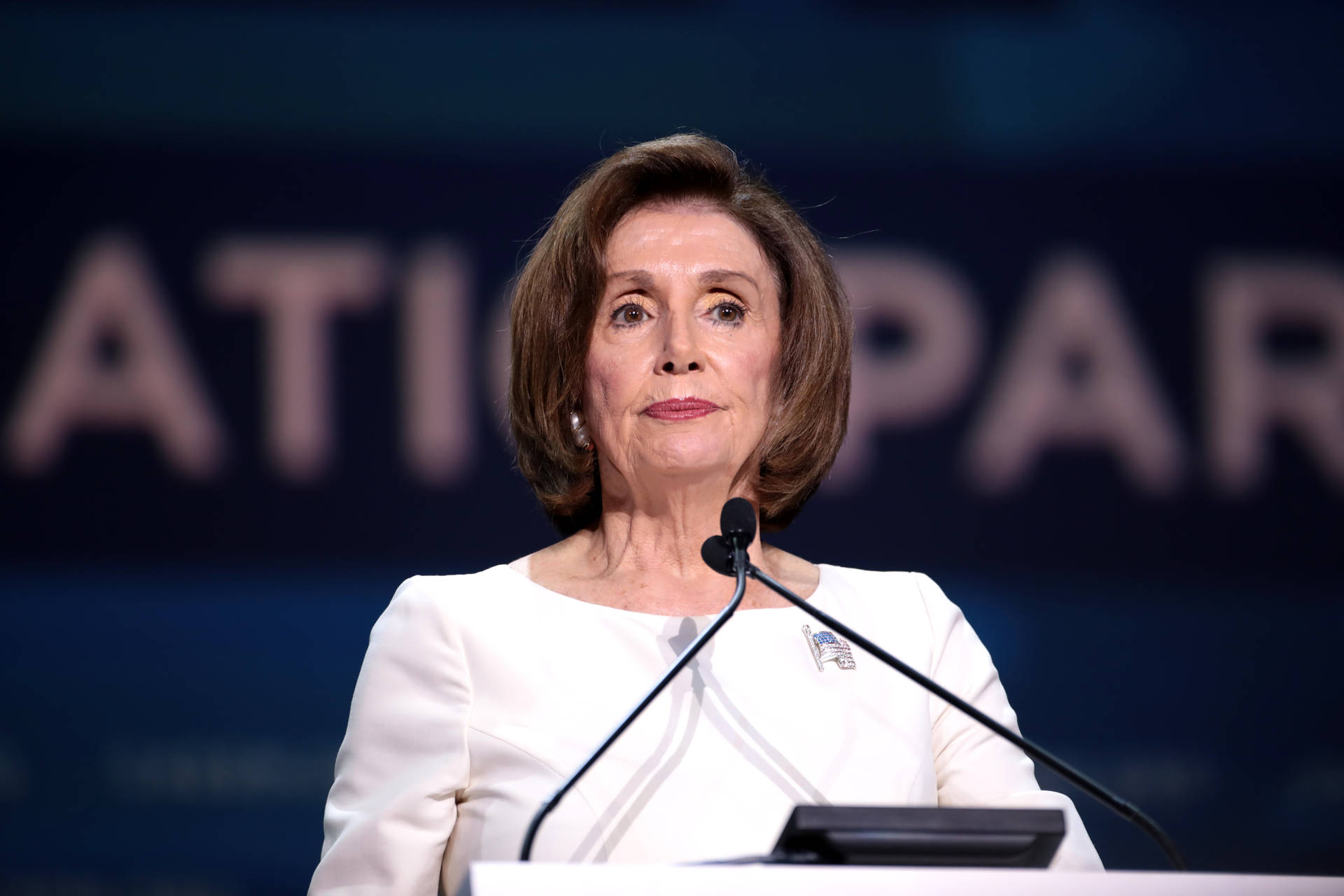 Nancy Pelosi At Event Podium Background