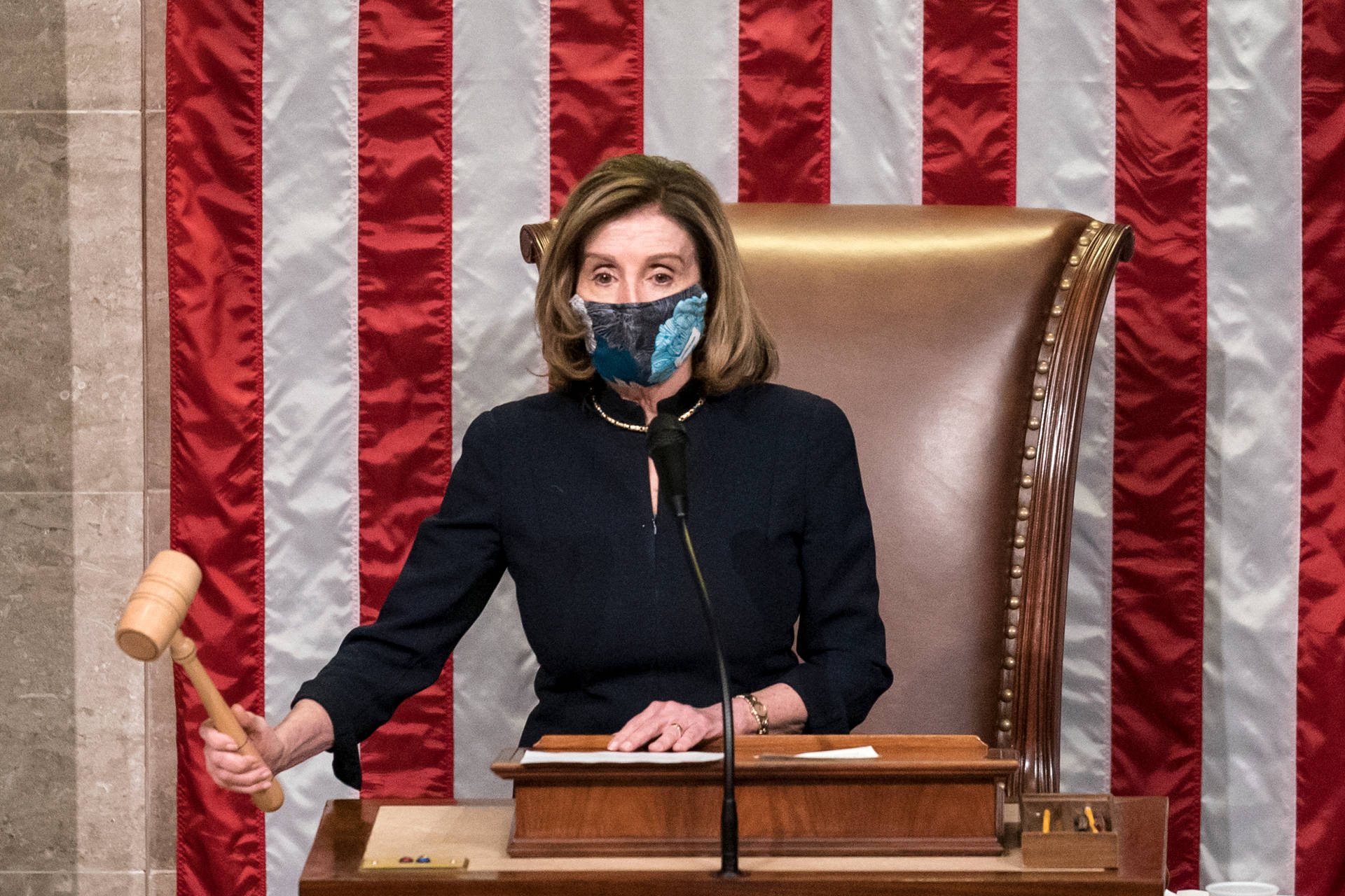 Nancy Pelosi Holding A Gavel While Wearing A Mask