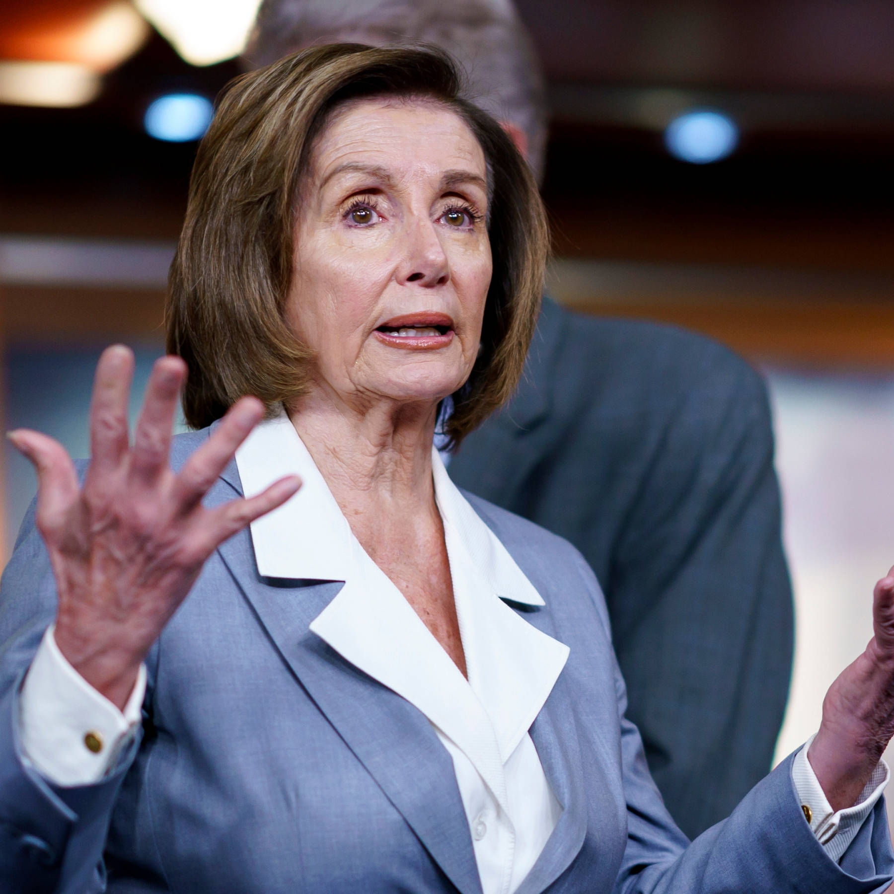 Nancy Pelosi In Blue Clothing Background