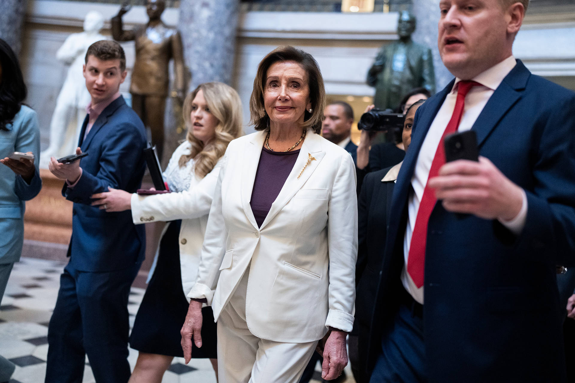 Nancy Pelosi Surrounded By Staff Background