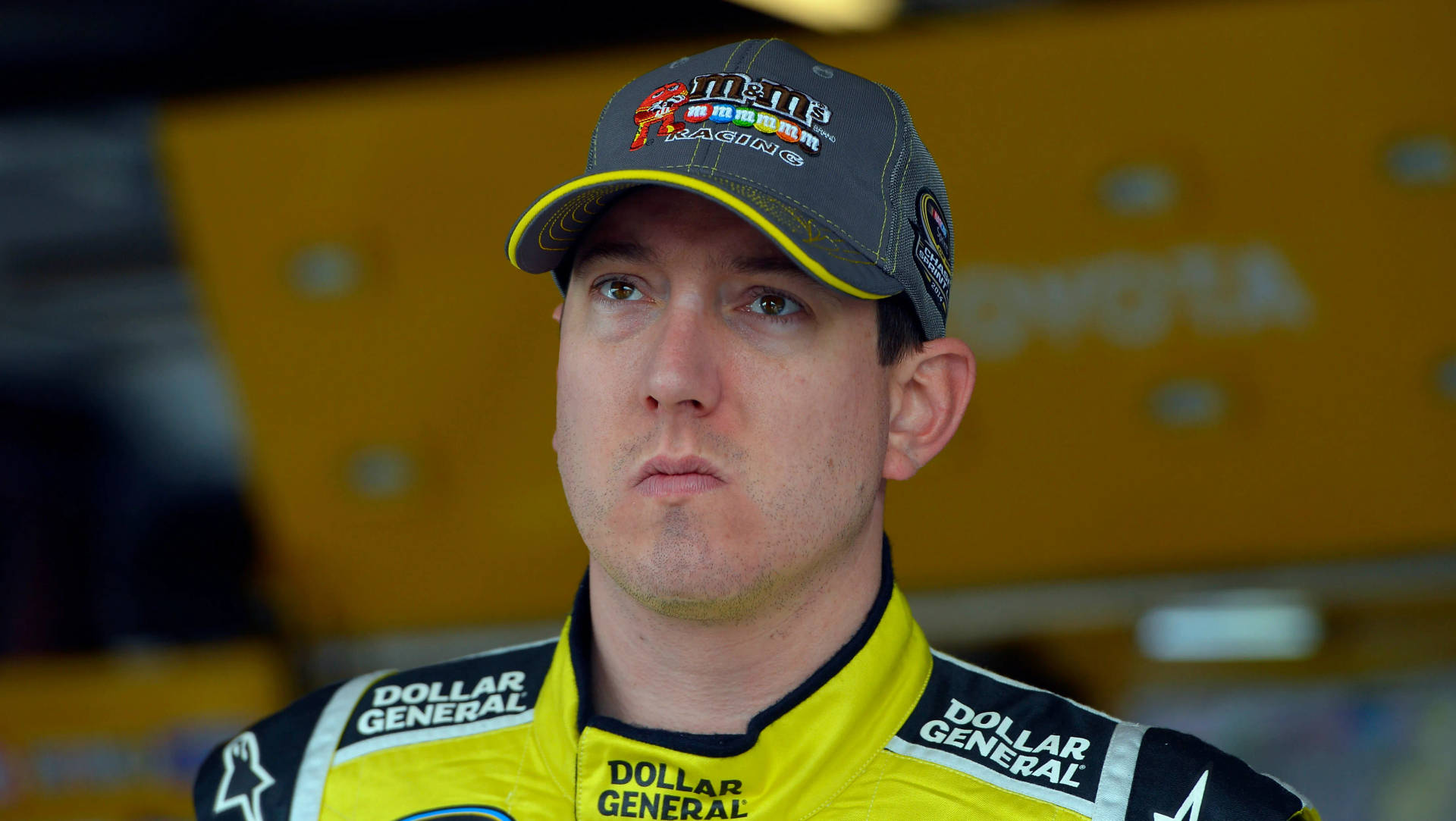 Nascar Champion Kyle Busch With A Blank Stare Background