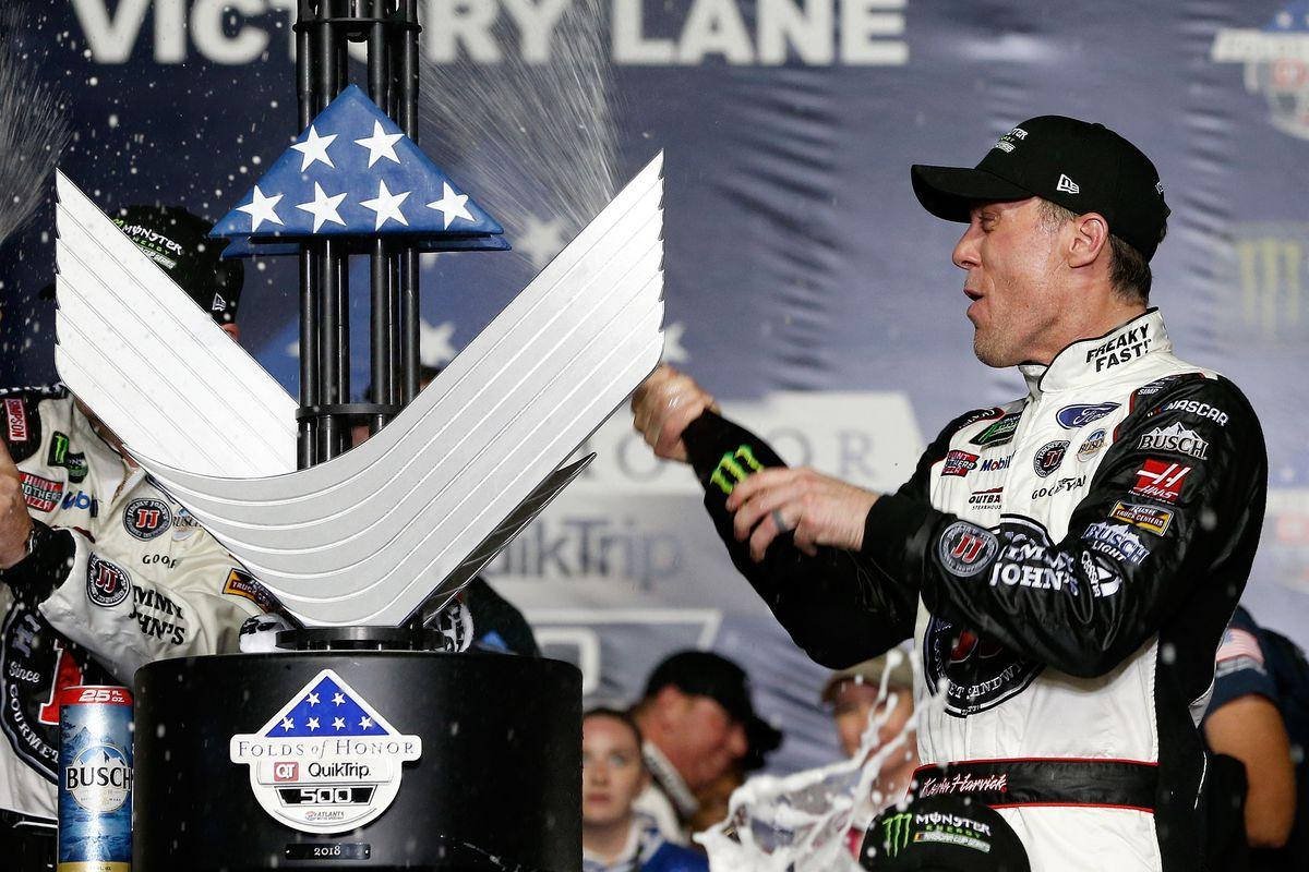 Nascar Racer Kevin Harvick Celebrating Victory With Champagne Splash. Background