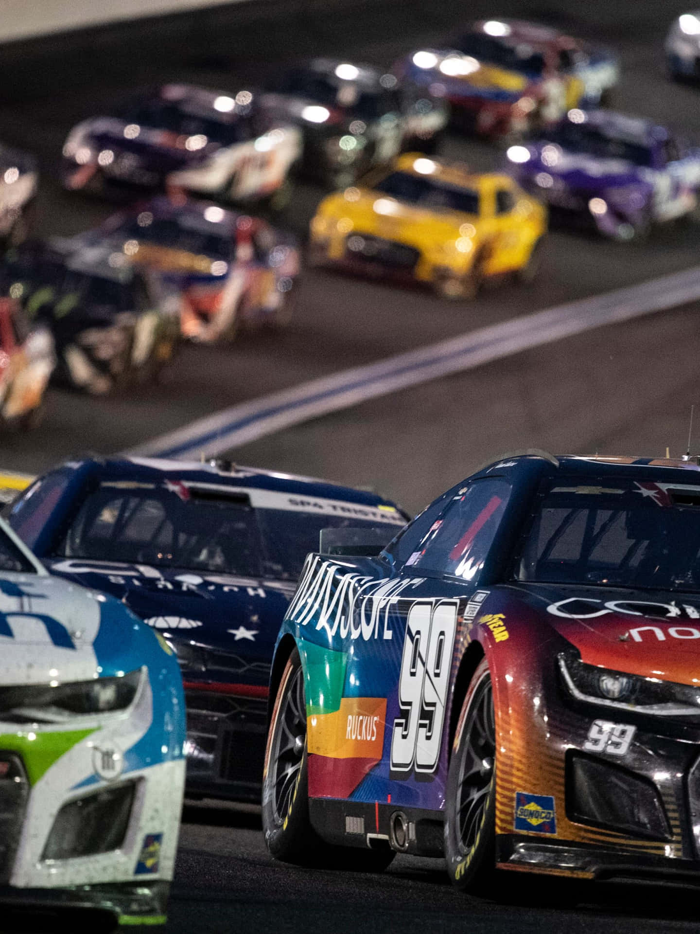 Nascar Races At Night With Cars In The Background Background
