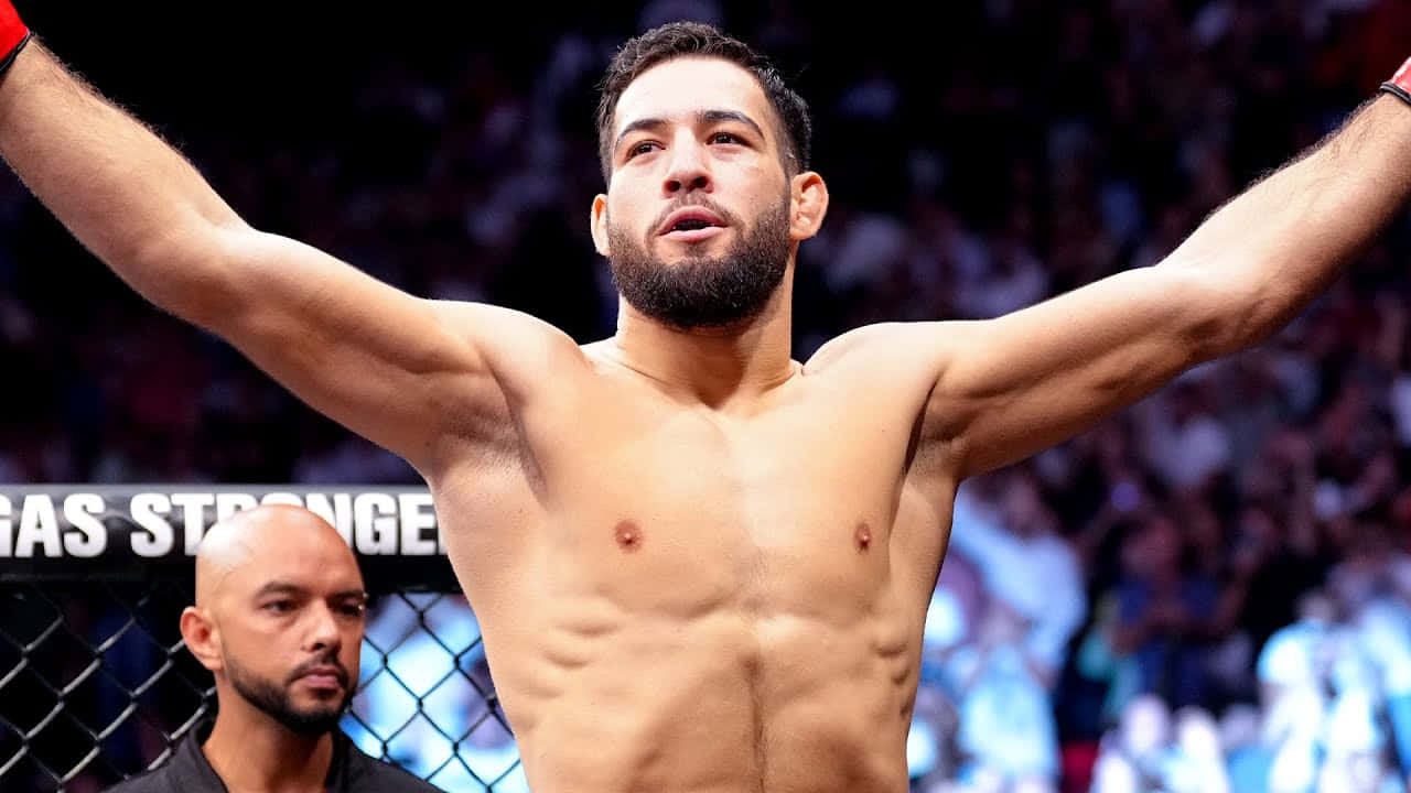 Nassourdine Imavov Raising Arms In Victory Background