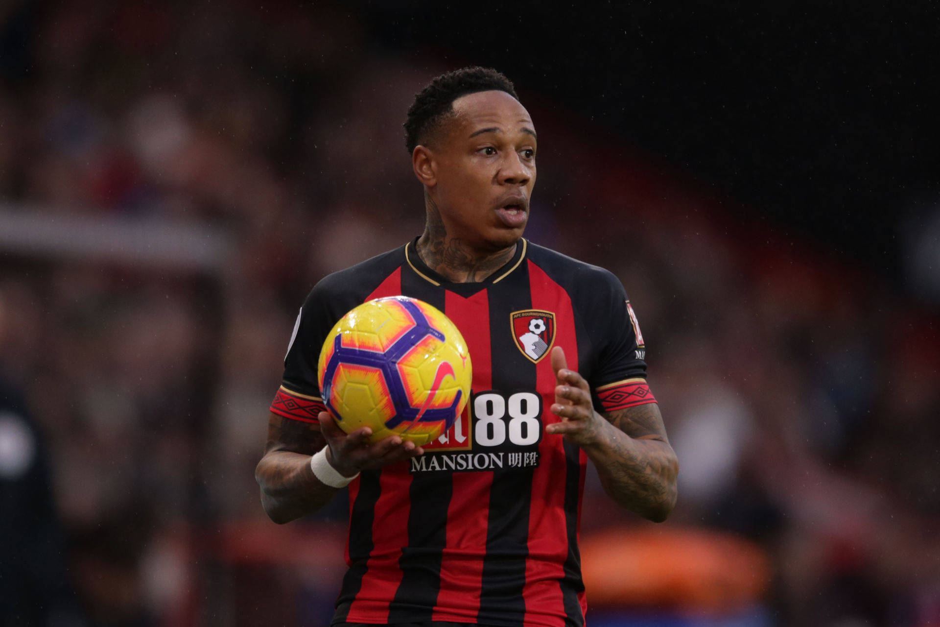 Nathaniel Clyne Holding A Ball Background